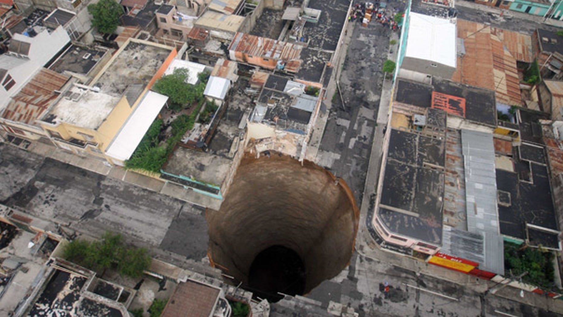 May 31: A giant sinkhole covers a street intersection in downtown Guatemala City.