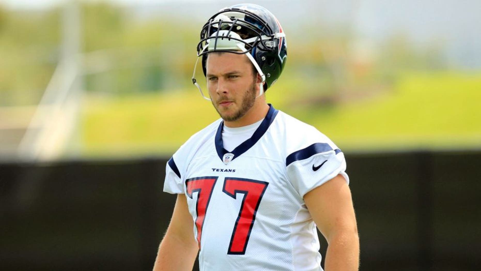 May 20, 2013; Houston, TX, USA; Houston Texans tackle David Quessenberry (77) works out during organized team activities at the Methodist Training Center at Reliant Stadium. Mandatory Credit: Thomas Campbell-USA TODAY Sports