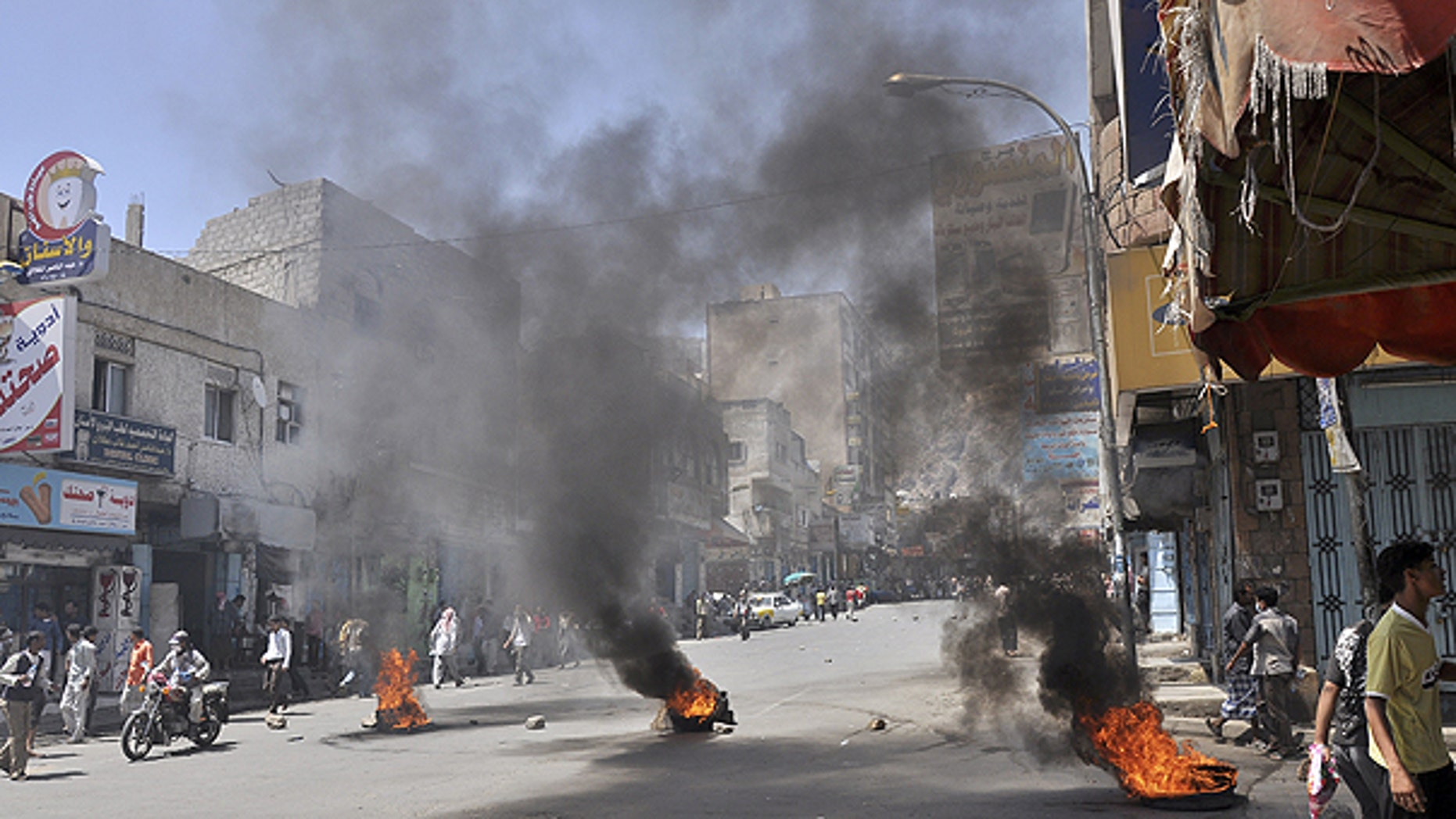 May 31: Burning tires left by anti-government protestors as they block the road during clashes with Yemeni security forces in Taiz, Yemen.