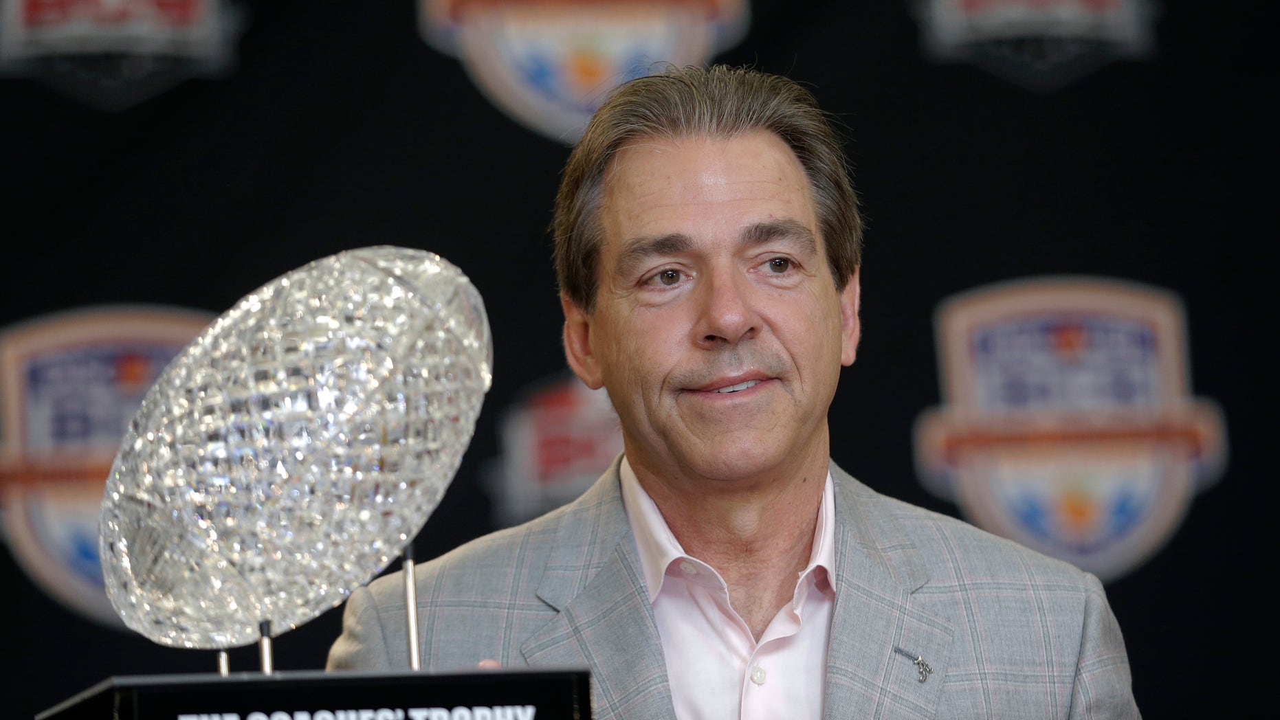 FILE -In a Jan. 8, 2013 file photo Alabama head coach Nick Saban poses with The Coaches' Trophy during a BCS National Championship college football game news conference in Ft. Lauderdale, Fla. By the time Dylan Moses is old enough to play football at Alabama, Nick Saban would be 65 and starting his 11th season at Tuscaloosa. (AP Photo/Morry Gash)
