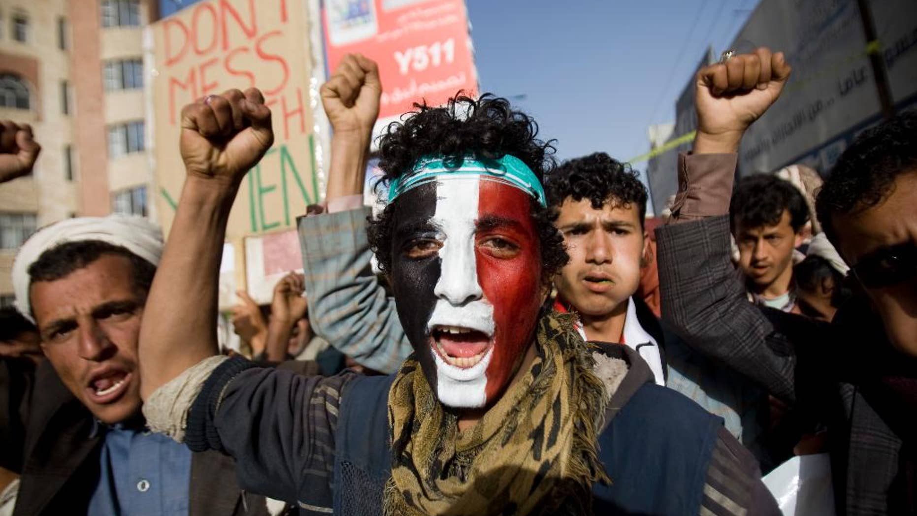A Houthi Shiite rebel with Yemen's flag painted on his face chants slogans during a rally to show support for leader of rebels, Abdel-Malik al-Houthi in Sanaa, Yemen, Friday, Feb. 27, 2015. Yemen's Shiite rebel leader lashed out at Saudi Arabia on Thursday, accusing it of seeking to split the country following his group's power grab, as a U.N. envoy met the embattled Yemeni president who has fled the capital, Sanaa. (AP Photo/Hani Mohammed)