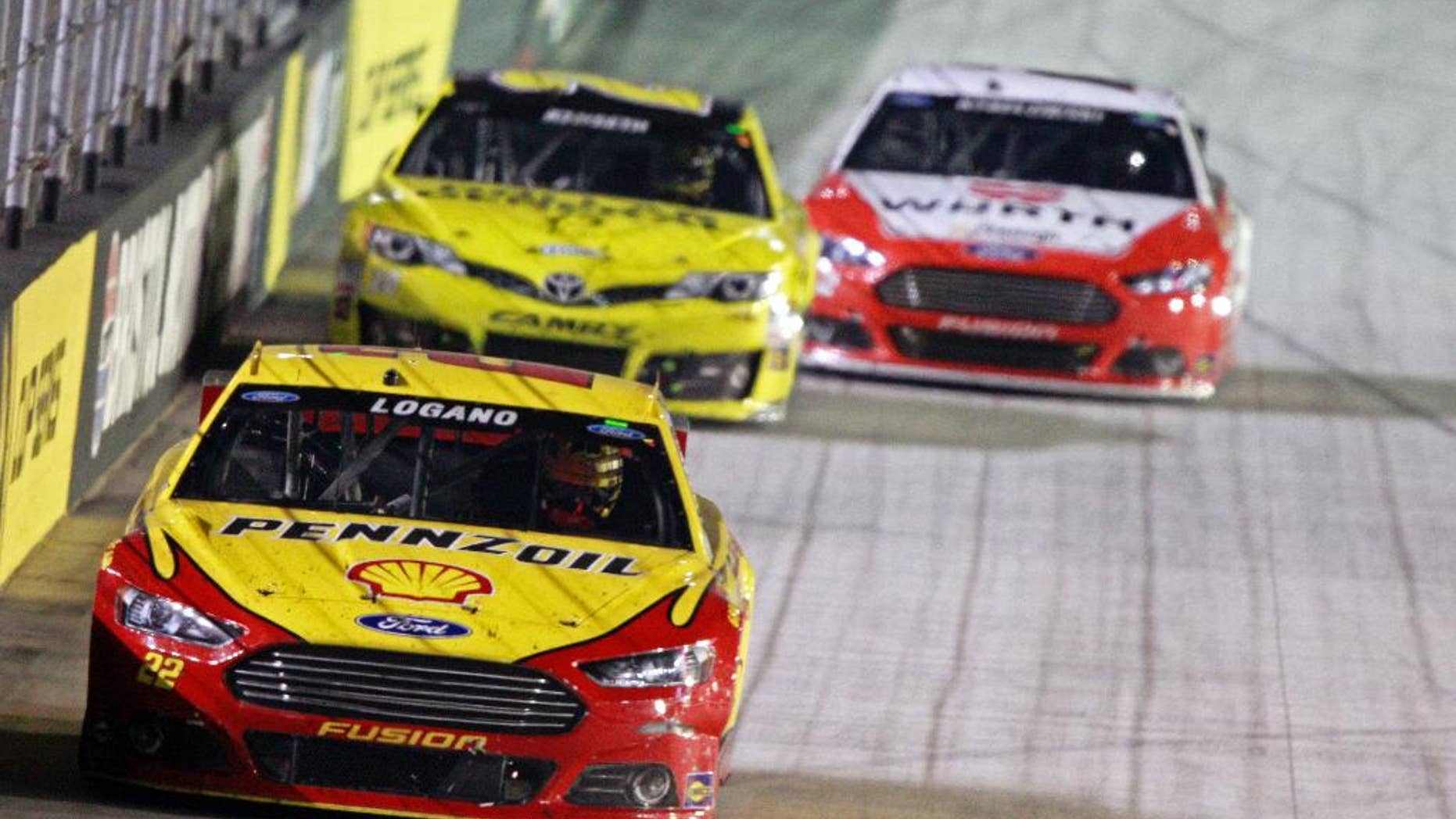 Driver Joey Logano (22) leads Matt Kenseth (20) and Brad Keselowski (2) during a NASCAR Sprint Cup Series auto race at Bristol Motor Speedway on Saturday, Aug. 23, 2014, in Bristol, Tenn. (AP Photo/Wade Payne)