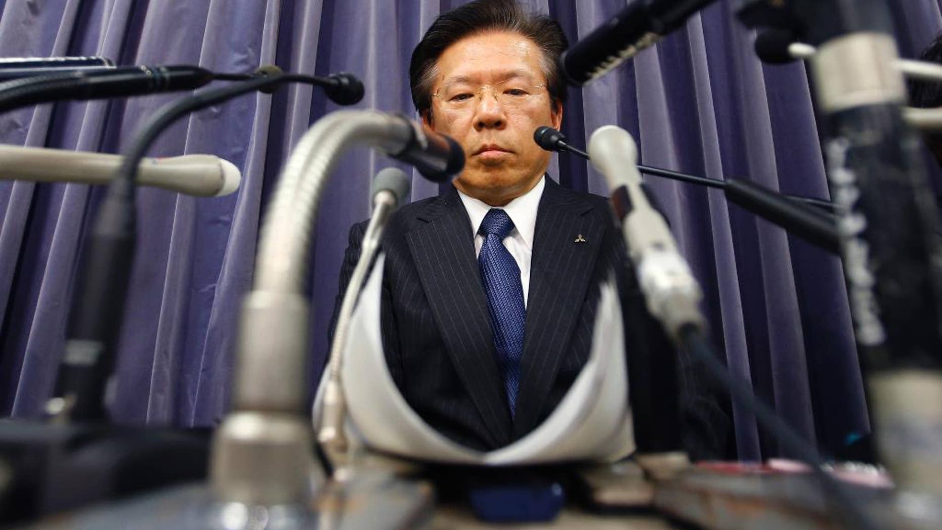 FILE - In this April 26, 2016, file photo, Mitsubishi Motors Corp. President Tetsuro Aikawa listens to a reporter's question during a press conference in Tokyo. The Japanese automaker said Friday, June 17, 2016, it will take a 50 billion yen ($913 million) charge to cover mileage-rigging expenses, including for the eK minicar models sold in Japan since 2013, and also under the Nissan label, as well as 30,000 yen ($290) compensation each for some other Mitsubishi models. (AP Photo/Shizuo Kambayashi, File)