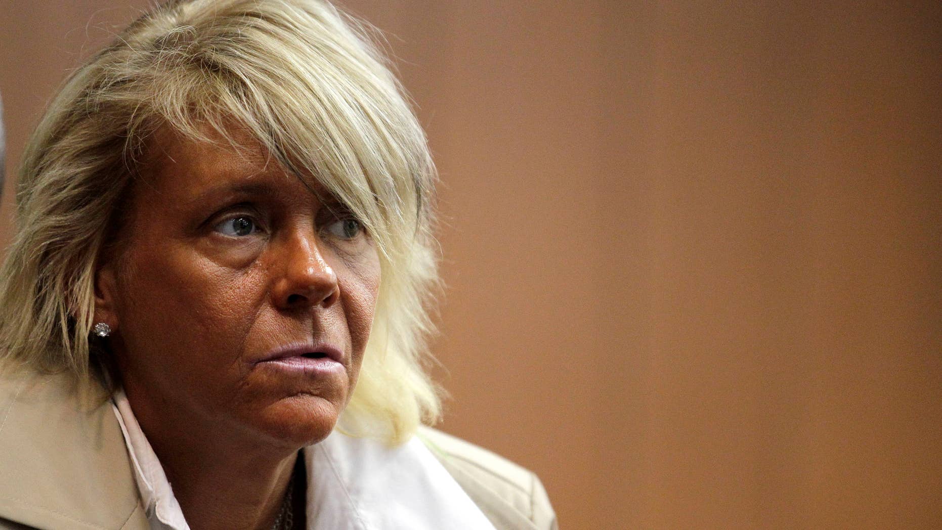 FILE - In this May 2, 2012 file photo, Patricia Krentcil, 44, waits to be arraigned at the Essex County Superior Court in Newark, N.J., where she appeared on charges of endangering her 5-year-old child by taking her into a tanning salon. A grand jury in New Jersey has decided to let Krentcil a woman who gained overnight notoriety as "the tanning mom" bronze away in peace. Prosecutors in Newark said Tuesday, Feb. 26, 2013 a grand jury refused to indict Patricia Krentcil on a charge she took her young daughter into a tanning booth with her. (AP Photo/Julio Cortez, File)