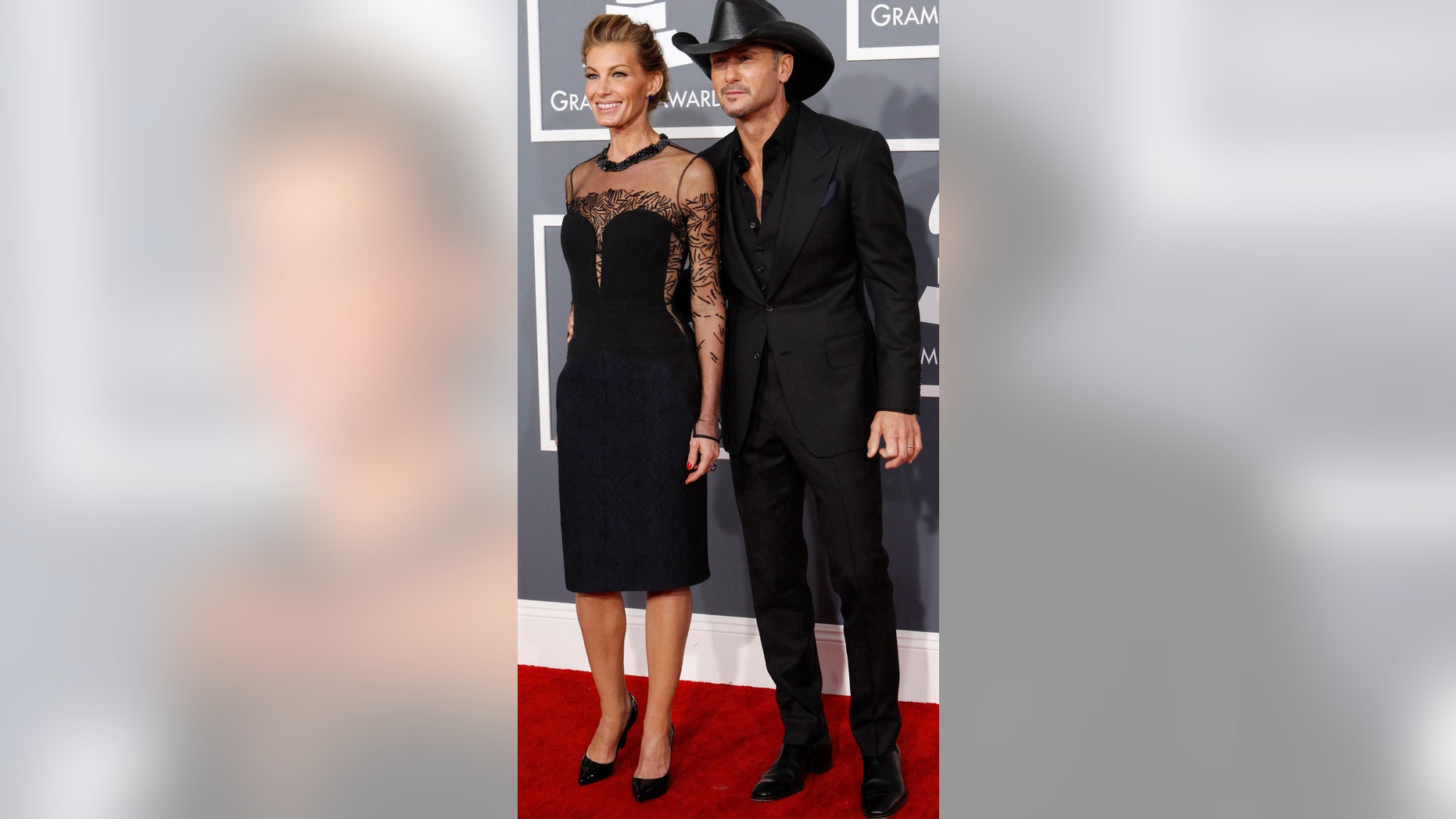 Country singers Faith HIll and her husband Tim McGraw arrive at the 55th annual Grammy Awards in Los Angeles, California February 10, 2013. REUTERS/Mario Anzuoni (UNITED STATES - Tags: ENTERTAINMENT) (GRAMMYS-ARRIVALS) - RTR3DM59