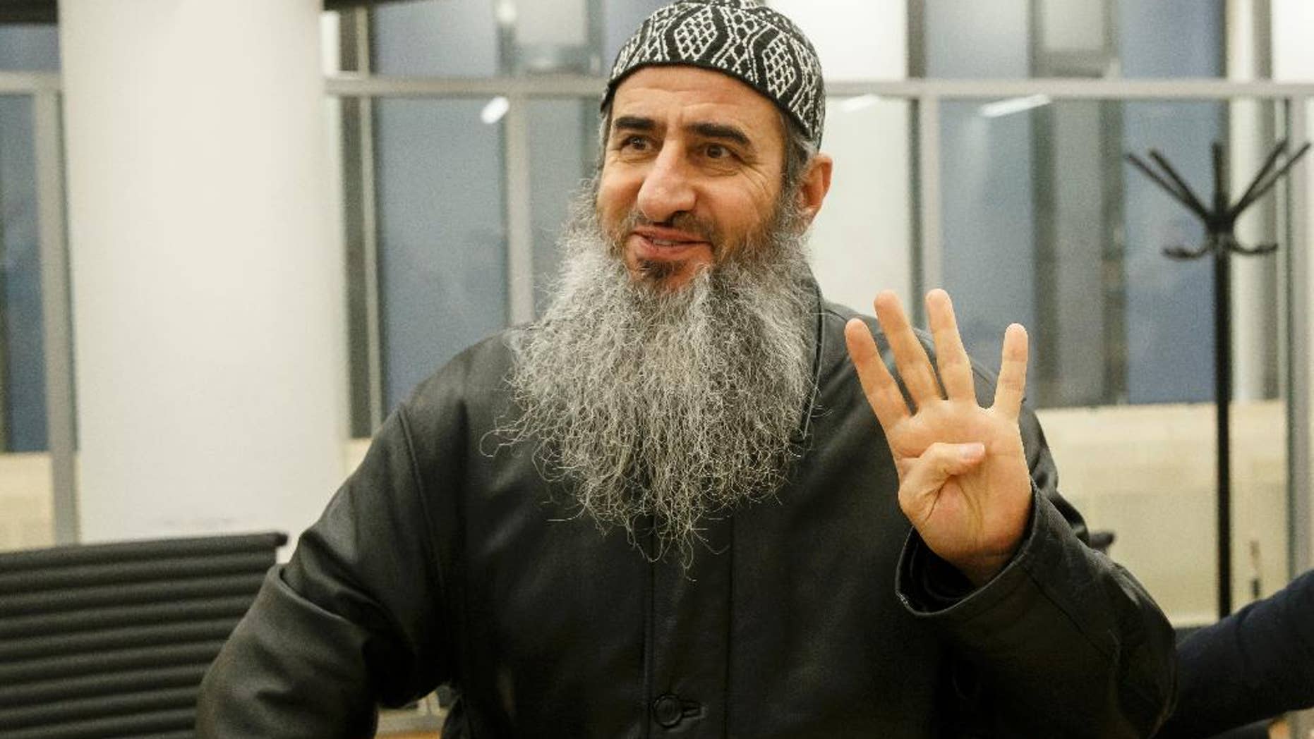 FILE - This is a Friday, Nov. 13, 2015 file photo of Najmaddin Faraj Ahmad, also known as Mullah Krekar, waves as he walks into court in Oslo. Norway's Supreme Court Wednesday Nov. 23, 2016 refused to hear an appeal by Najmaddin Faraj Ahmada radical Iraqi-born cleric who is trying to fight extradition to Italy, which suspects him of enticing recruits to fight in Iraq and Syria. The decision paves the way for Norway to hand over the cleric, to Italian authorities. (Cornelius Poppe / NTB scanpix, File via AP)