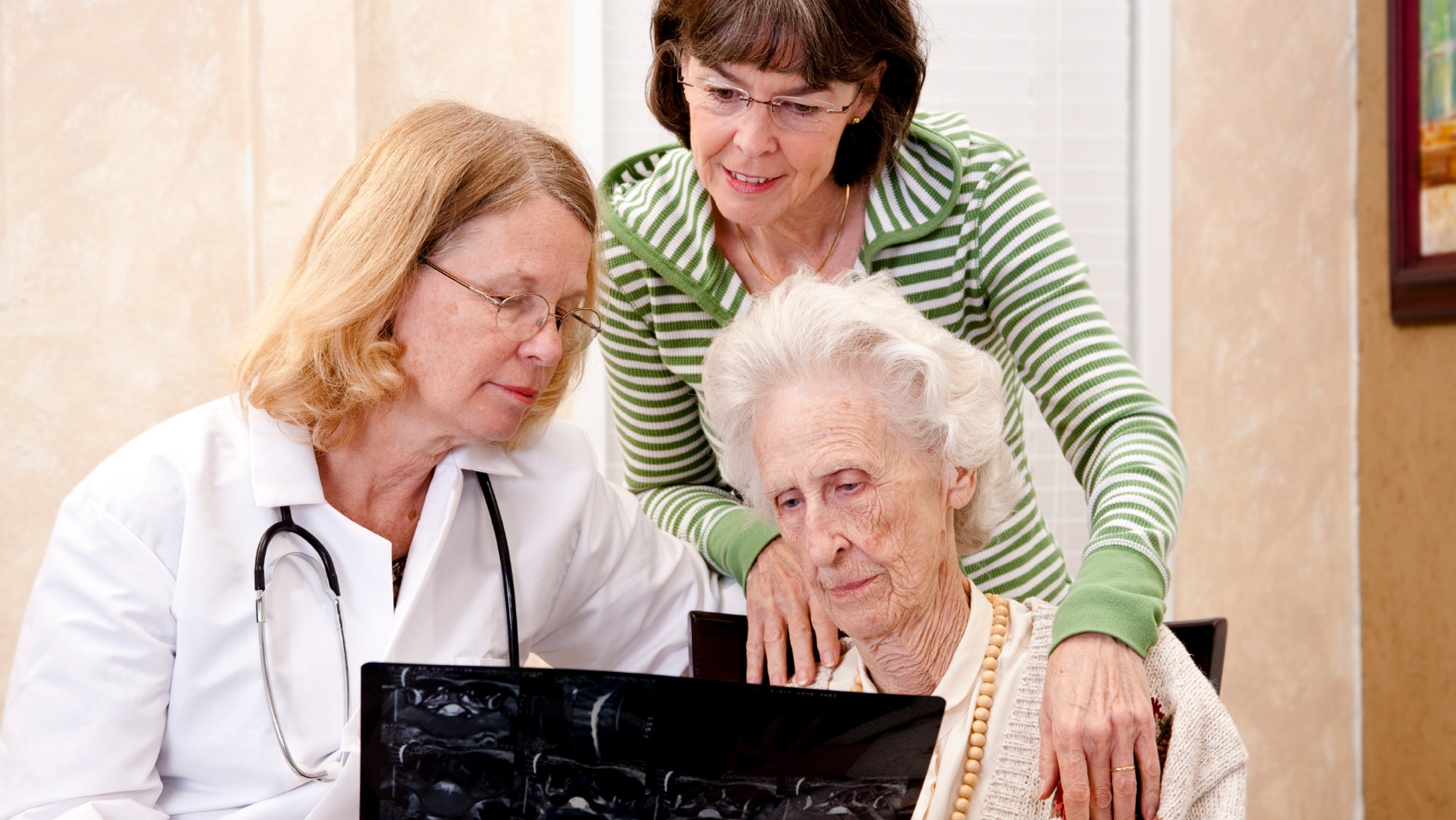 Senior woman visiting with her doctor or caregiver