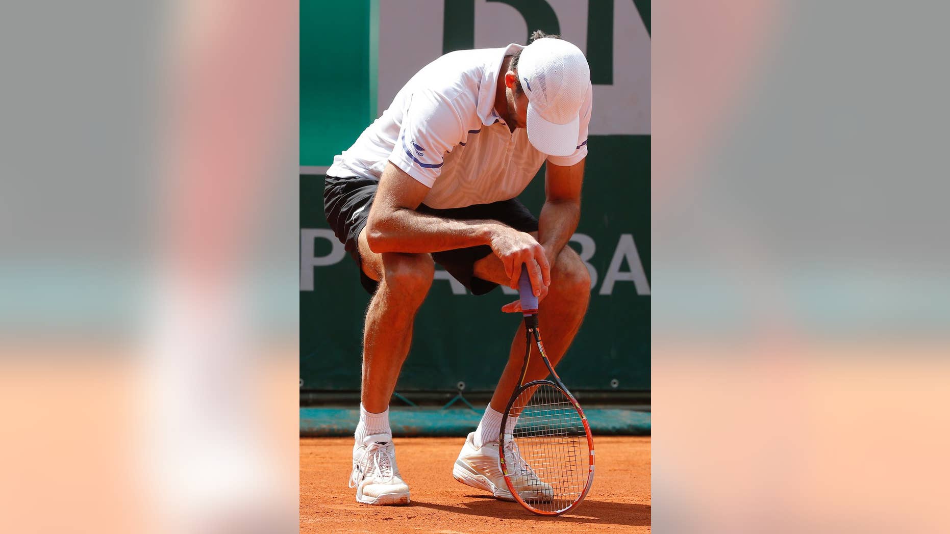 Croatia's Ivo Karlovic looks down as he plays South Africa's Kevin Anderson during their third round match of the French Open tennis tournament at the Roland Garros stadium, in Paris, France, Saturday, May 31, 2014. (AP Photo/Michel Euler)