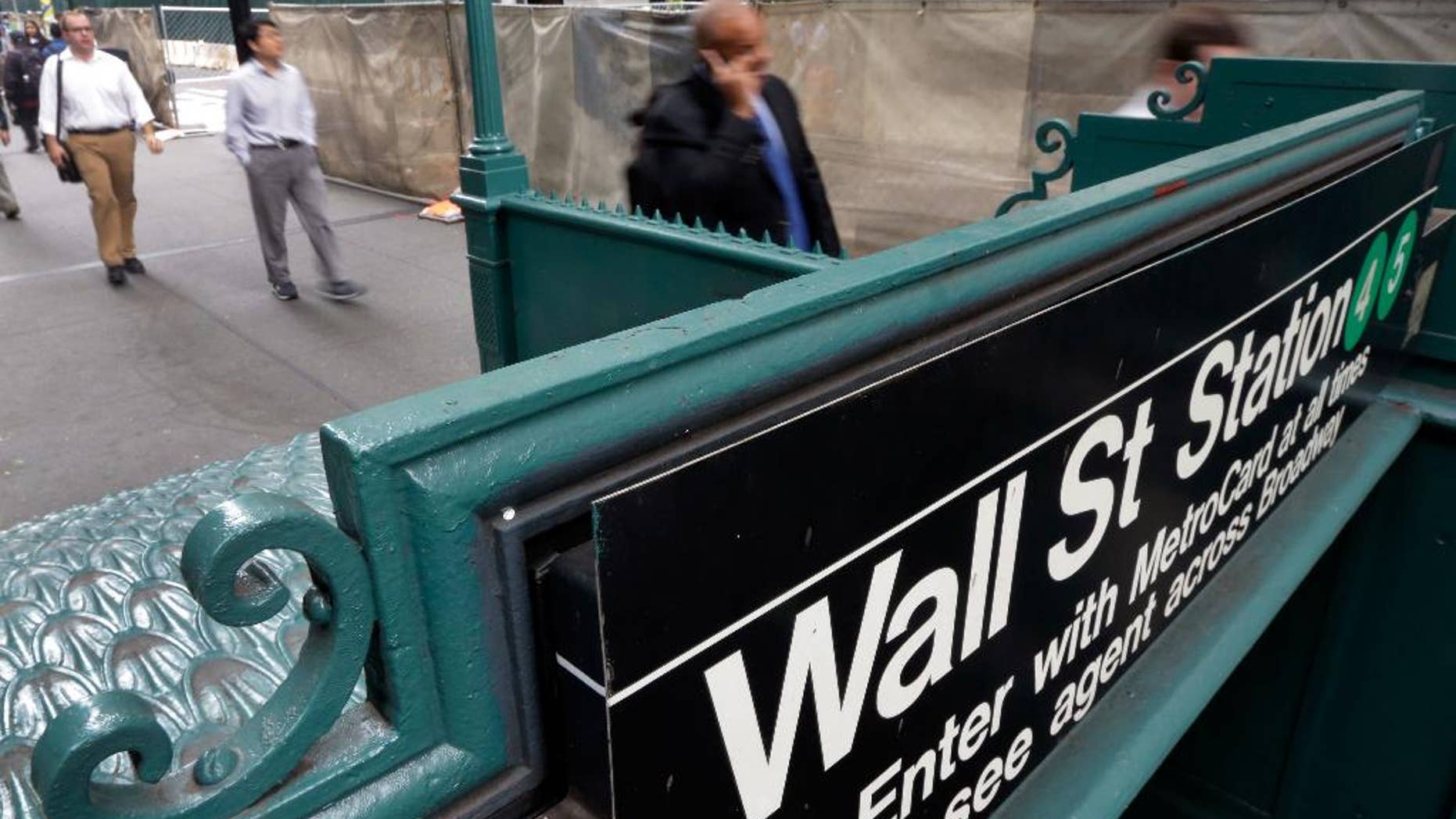 The Wall Street subway stop on Broadway, in New York's Financial District, Thursday, Oct. 2, 2014. U.S. financial markets surged in early trading Friday, Nov. 21, 2014 as investors cheered a surprise interest rate cut in China and a hint of further stimulus for Europe from the head of the region's central bank. The rally extended gains from a day before, pushing the major market indexes further into record territory. (AP Photo/Richard Drew)