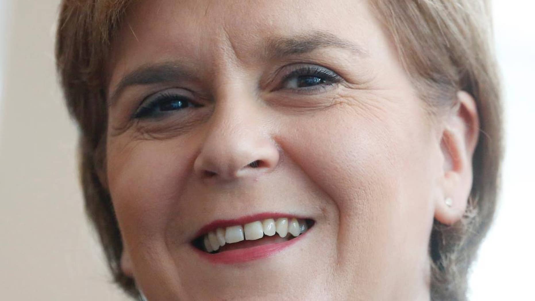 FILE - In this Thursday, July 30, 2015, file photo, First Minister of Scotland Nicola Sturgeon smiles during the opening ceremony of the Scotland Hong Kong Centre for Carbon Innovation in Hong Kong. On Tuesday, Sturgeon says Scotland should be able to remain part of the European Union without leaving the United Kingdom. (AP Photo/Kin Cheung, File)