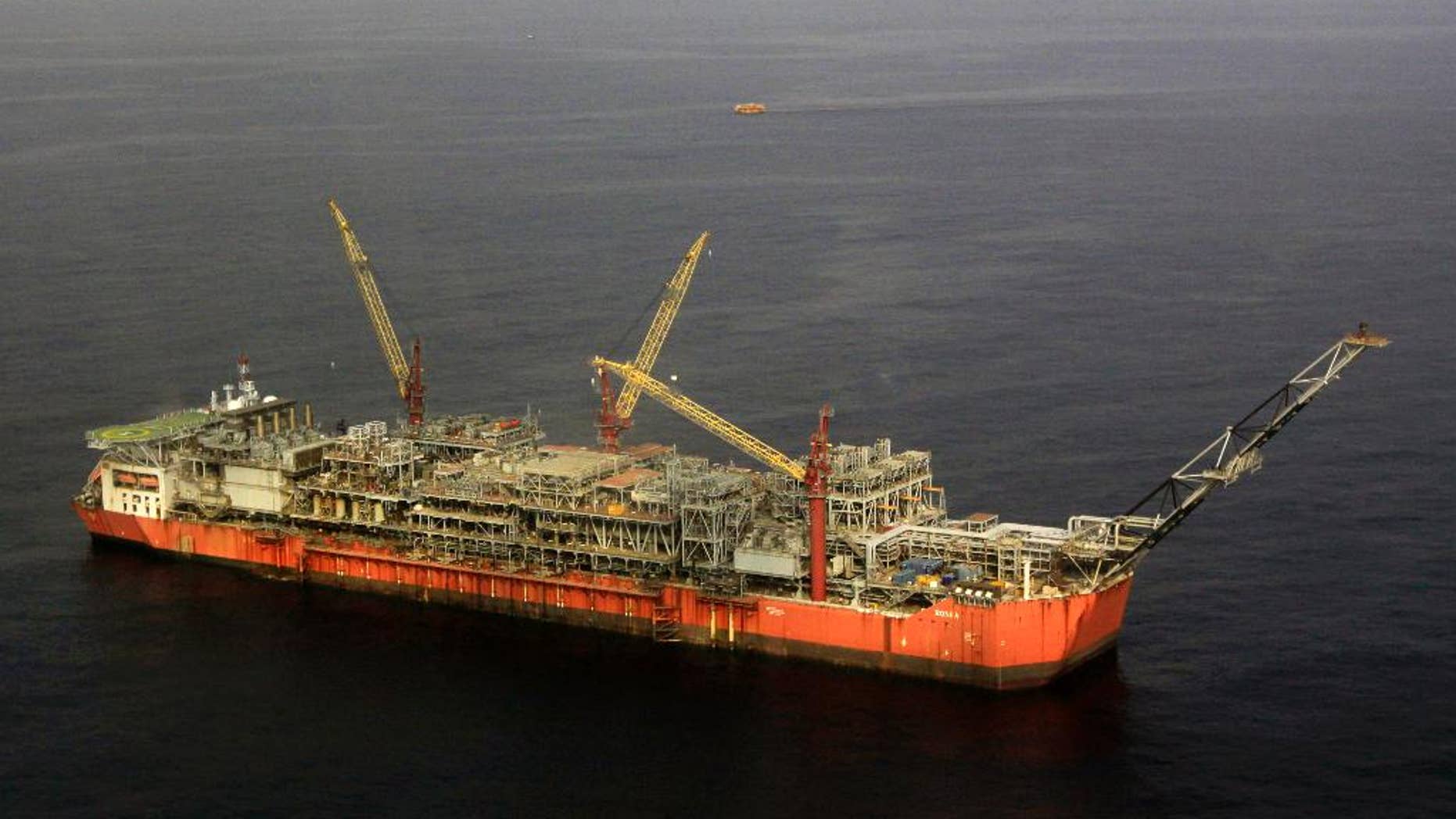 FILE - In this Monday, Dec. 26, 2011 file photo, Shell Bonga offshore oil Floating Production Storage and Offloading vessel off the coast of the Niger Delta in Nigeria. Shell closed the terminal exporting Nigeria's benchmark Bonny Light crude oil on Wednesday May 11, 2016 and was evacuating workers from a threatened oil field as renewed militant attacks cut production in Africa's biggest petroleum producer, the company and a union leader said. (AP Photo/Sunday Alamba, file)