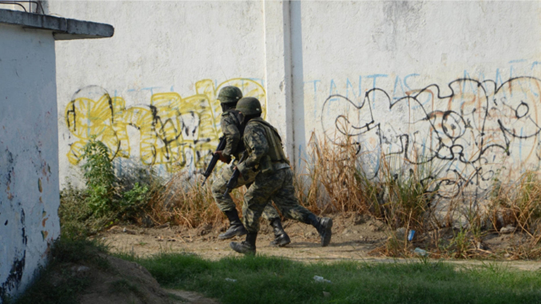 May 30: Soldiers give chase after men that were riding in a car that crashed and fell into a ditch, tried to escape while being pursued by federal authorities in Acapulco, Mexico.