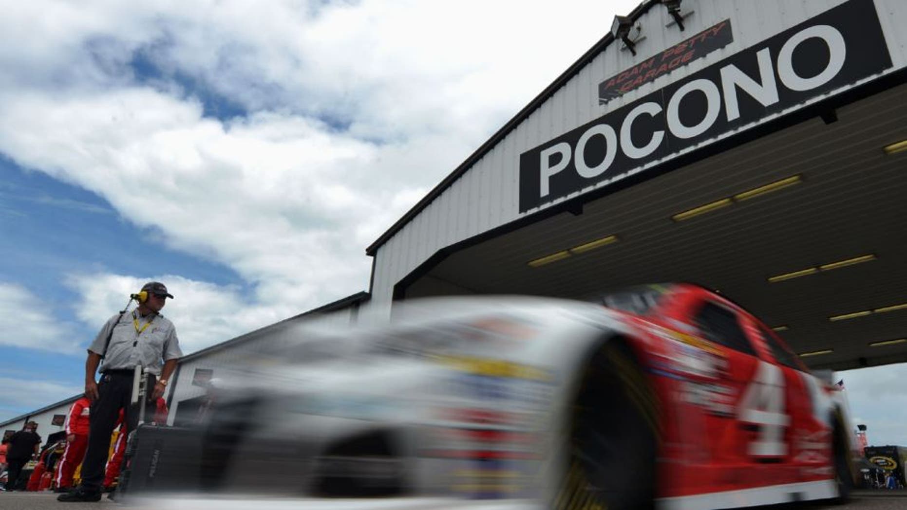 LONG POND, PA - JUNE 05: Kevin Harvick, driver of the #4 Budweiser/Jimmy John's Chevrolet, drives through the garage area during practice for the NASCAR Sprint Cup Series Axalta "We Paint Winners" 400 at Pocono Raceway on June 5, 2015 in Long Pond, Pennsylvania. (Photo by Drew Hallowell/Getty Images)