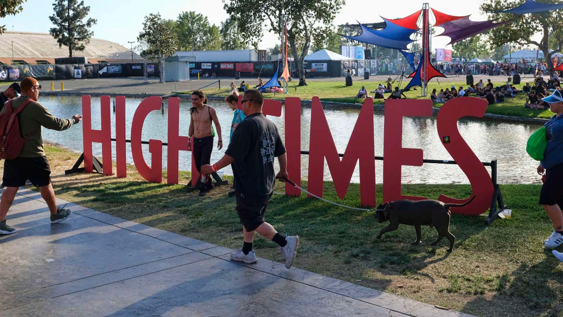 FILE - In this Sunday, April 23, 2017, file photo, visitors arrive at the fairgrounds to attend the High Times Cannabis Cup in San Bernardino, Calif.
