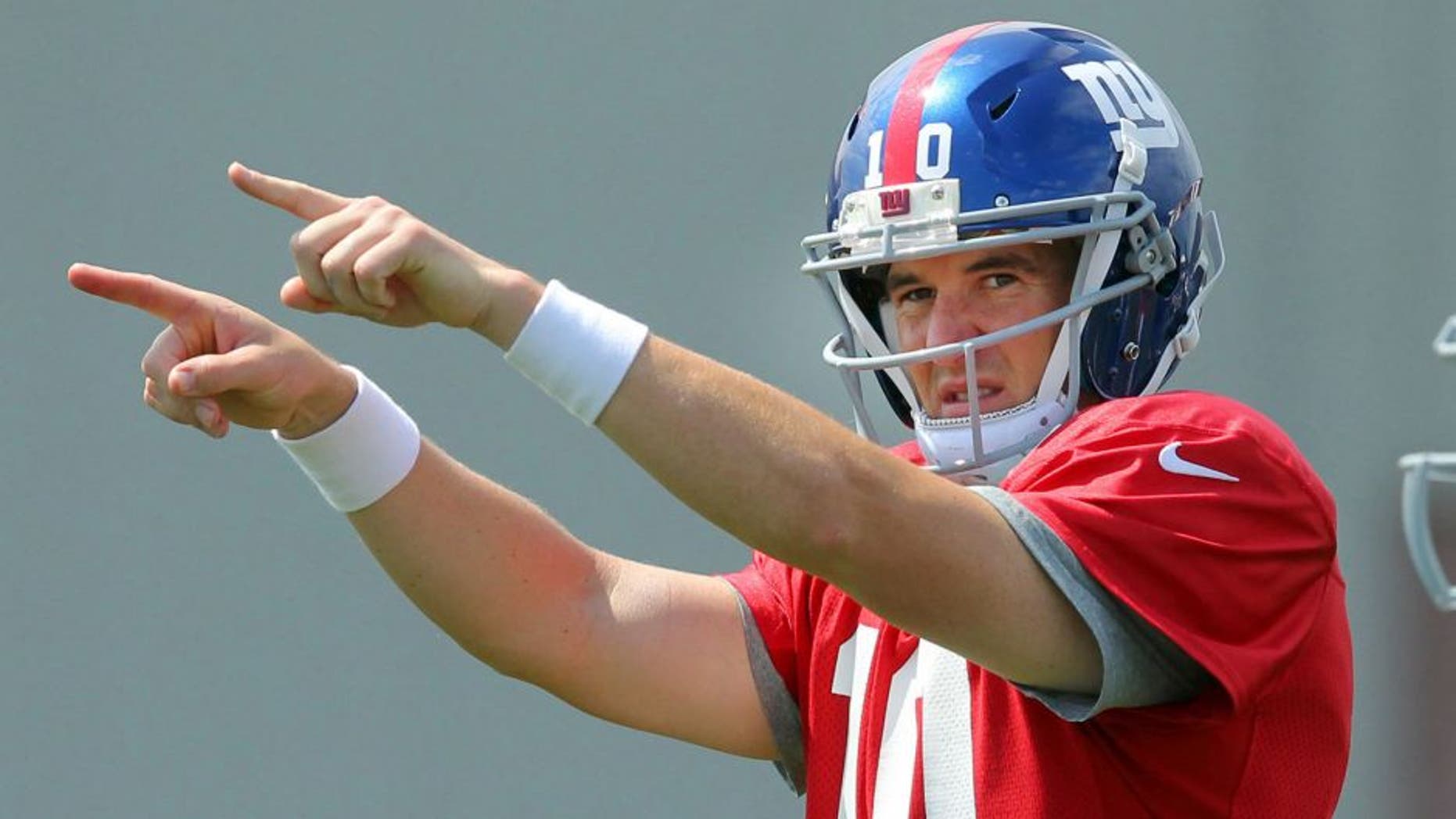 Aug 7, 2013; East Rutherford, NJ, USA; New York Giants quarterback Eli Manning (10) calls out signals in front of running back David Wilson (22) during team practice at the Quest Diagnostics Training Center. Mandatory Credit: Brad Penner-USA TODAY Sports