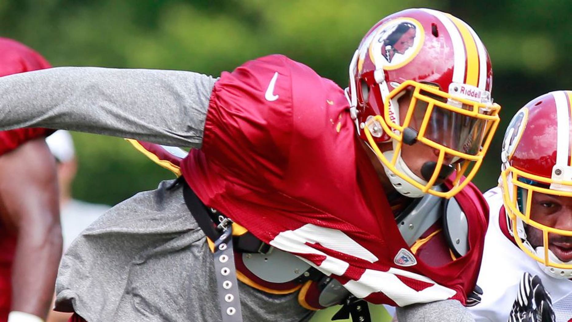 July 30, 2012; Ashburn, VA, USA; Washington Redskins running back Lennon Creer (23) attempts to block Redskins linebacker Keenan Robinson (52) during Redskins training camp at Redskins Park. Mandatory Credit: Geoff Burke-USA TODAY Sports
