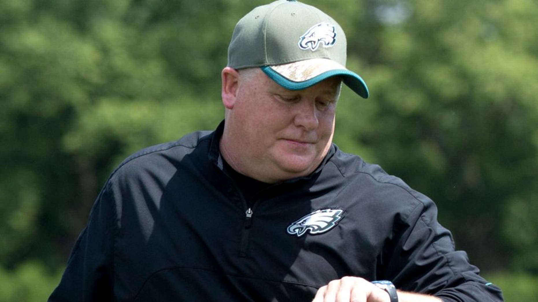 May 28, 2015; Philadelphia, PA, USA; Philadelphia Eagles head coach Chip Kelly checks his watch during OTA's at the NovaCare Complex. Mandatory Credit: Bill Streicher-USA TODAY Sports