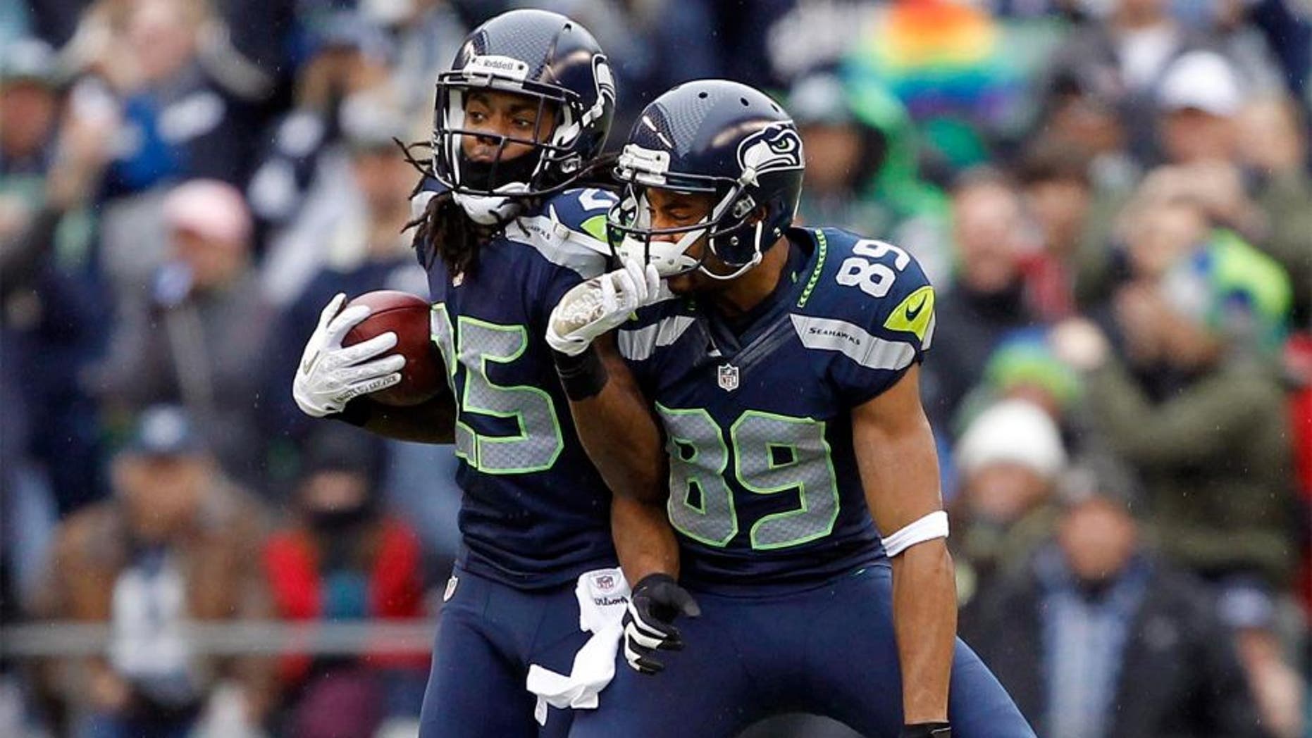 Nov 11, 2012; Seattle, WA, USA; Seattle Seahawks cornerback Richard Sherman (25) and Seattle Seahawks wide receiver Doug Baldwin (89) celebrate an interception by Sherman against the New York Jets during the second quarter at CenturyLink Field. Mandatory Credit: Joe Nicholson-USA TODAY Sports
