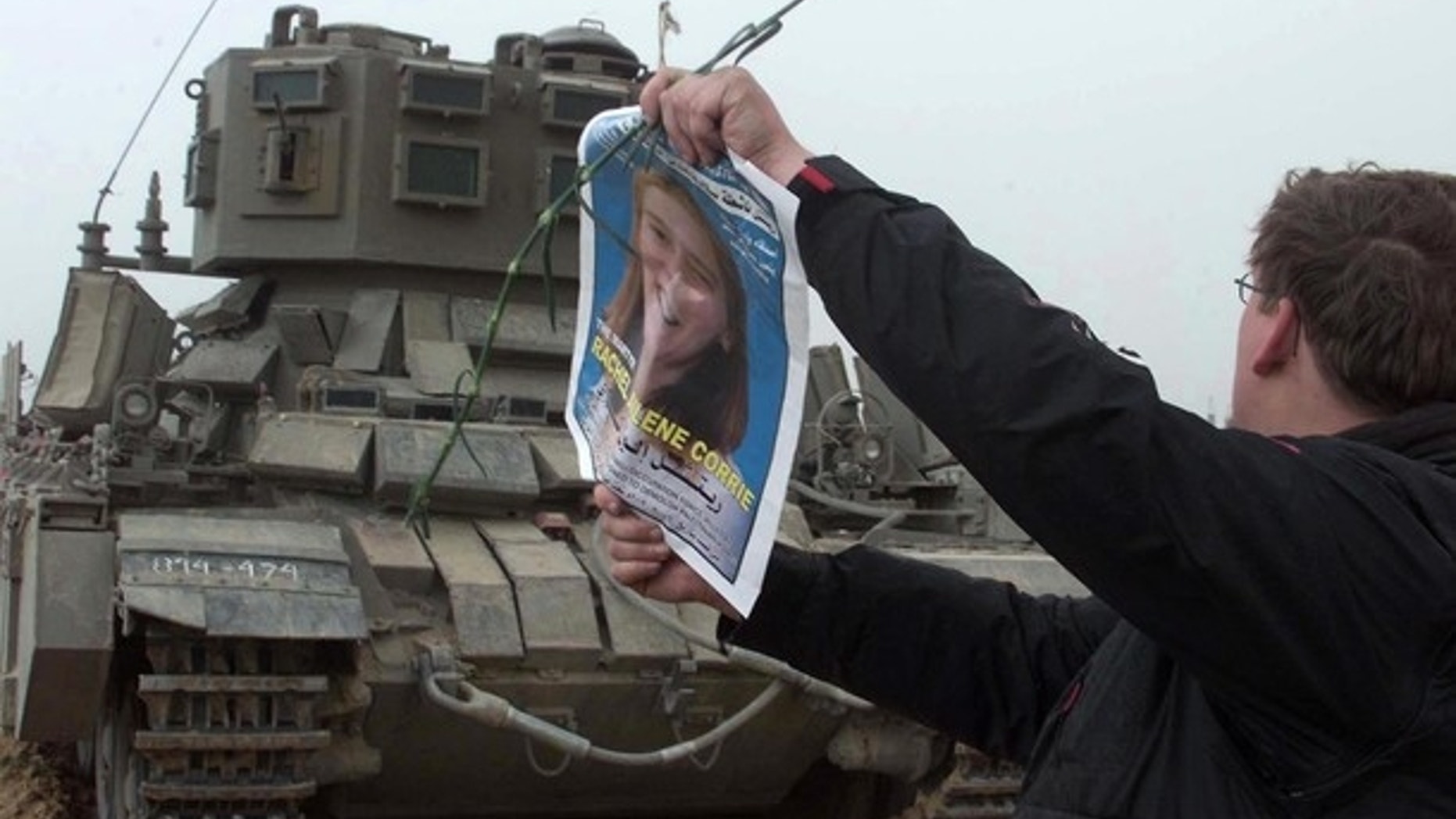 FILE: A member of the International Solidarity Movement waves a picture of pro-Palestinian activist Rachel Corrie in front of an Israeli tank during a demonstration held at the site where Corrie was killed in March 2003.
