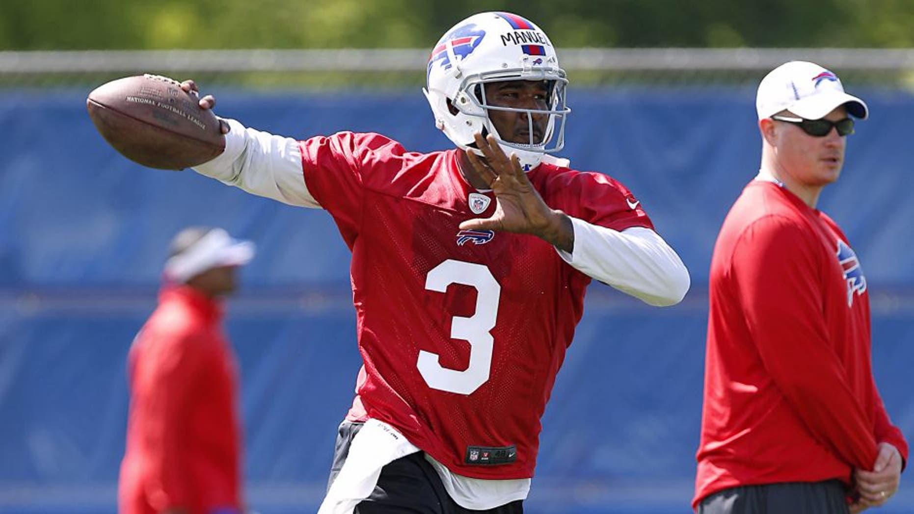 May 28, 2014; Buffalo, NY, USA; Buffalo Bills quarterback EJ Manuel (3) rolls out to pass as Bills offensive coordinator Nathaniel Hackett looks on during organized team activities at Ralph Wilson Stadium. Mandatory Credit: Kevin Hoffman-USA TODAY Sports