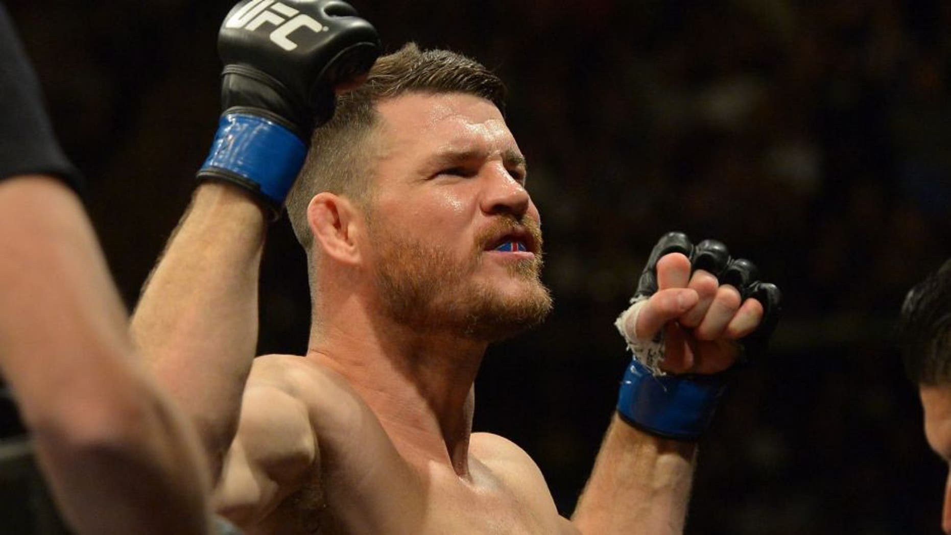 INGLEWOOD, CA - JUNE 04: Michael Bisping raises his arms to the crowd as he enters the cage for his middleweight championship bout at UFC 199 at The Forum on June 4, 2016 in Inglewood, California. (Photo by Jayne Kamin-Oncea/Getty Images)