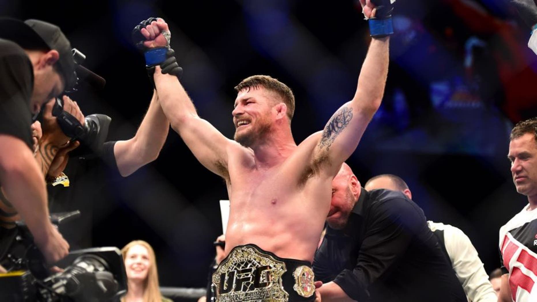 INGLEWOOD, CA - JUNE 04: Michael Bisping of England celebrates after his first round knockout win against Luke Rockhold in their UFC middleweight championship bout during the UFC 199 event at The Forum on June 4, 2016 in Inglewood, California. (Photo by Harry How/Zuffa LLC/Zuffa LLC via Getty Images)