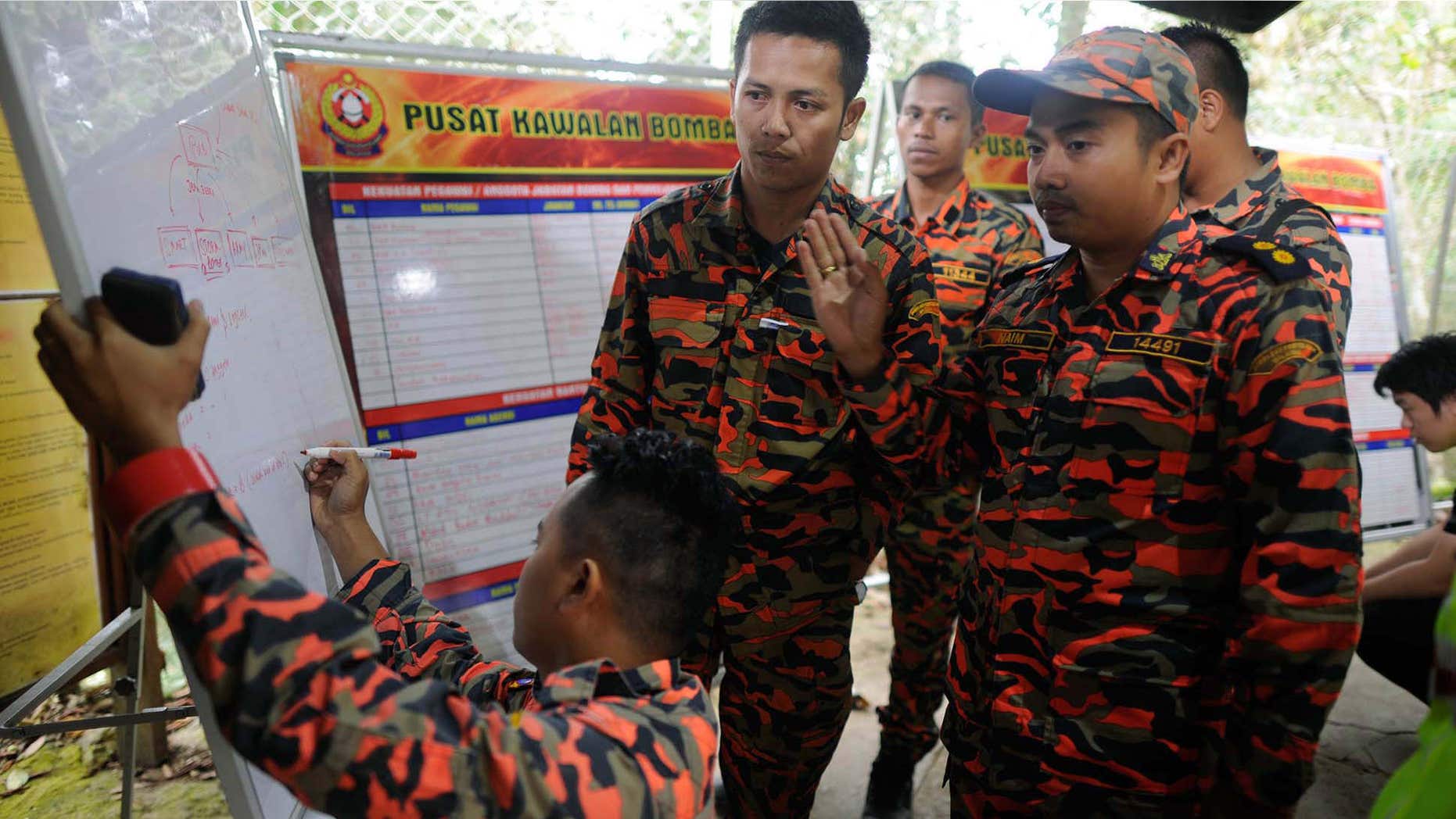 June 6, 2015: Members of the Malaysian rescue team plan as they wait for victims to be evacuated a day after an earthquake in Kundasang, a town in the district of Ranau, Malaysia.