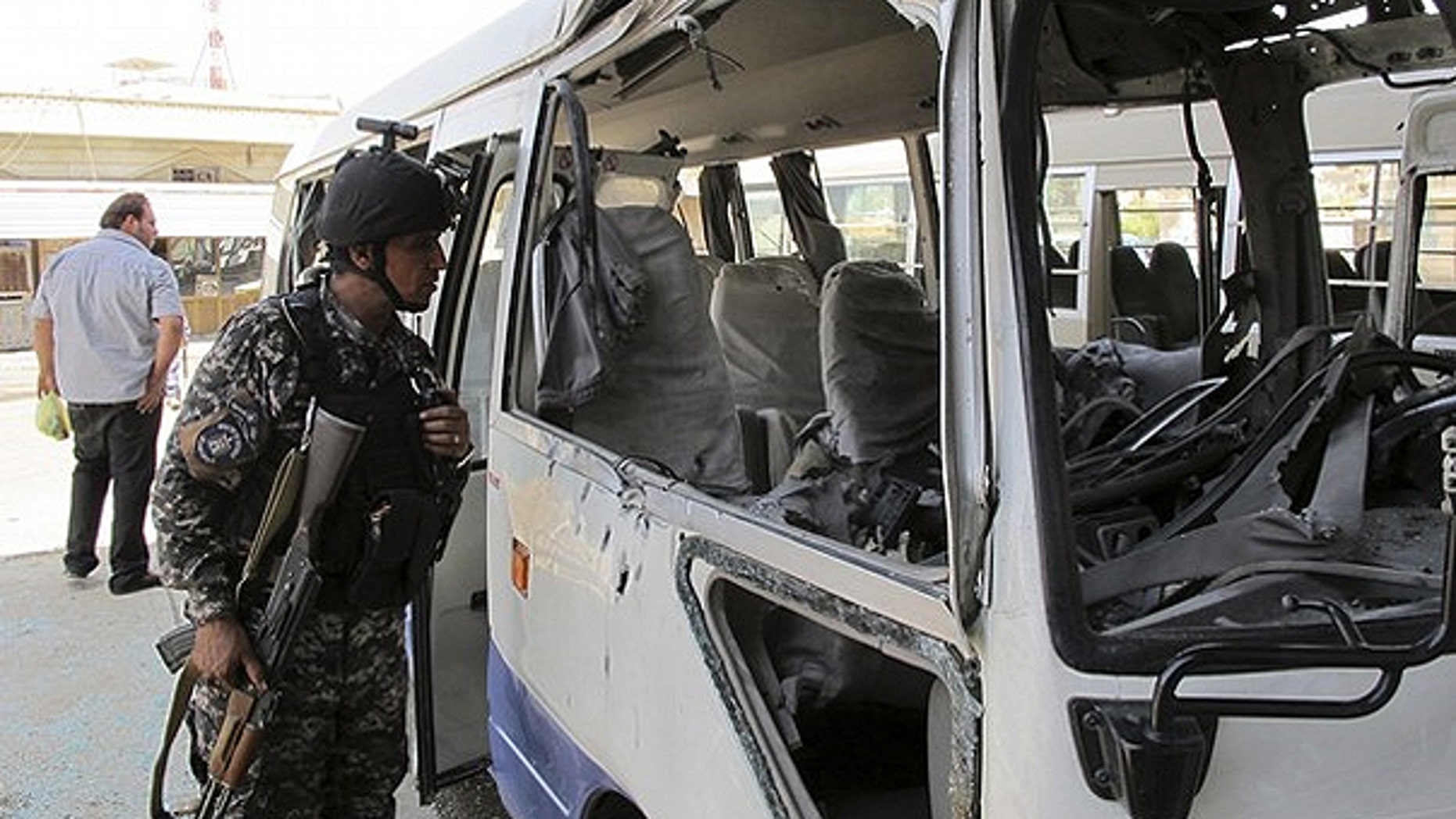 May 15: A policeman inspects a damaged bus after a rocket landed in central Baghdad. One person was killed and nine others wounded when nine Katyusha rockets landed in Baghdad's fortified Green Zone, where the U.S. embassy and Iraqi government officials' houses are located, and other central and southern areas of the Iraqi capital, the Baghdad security operations centre said.