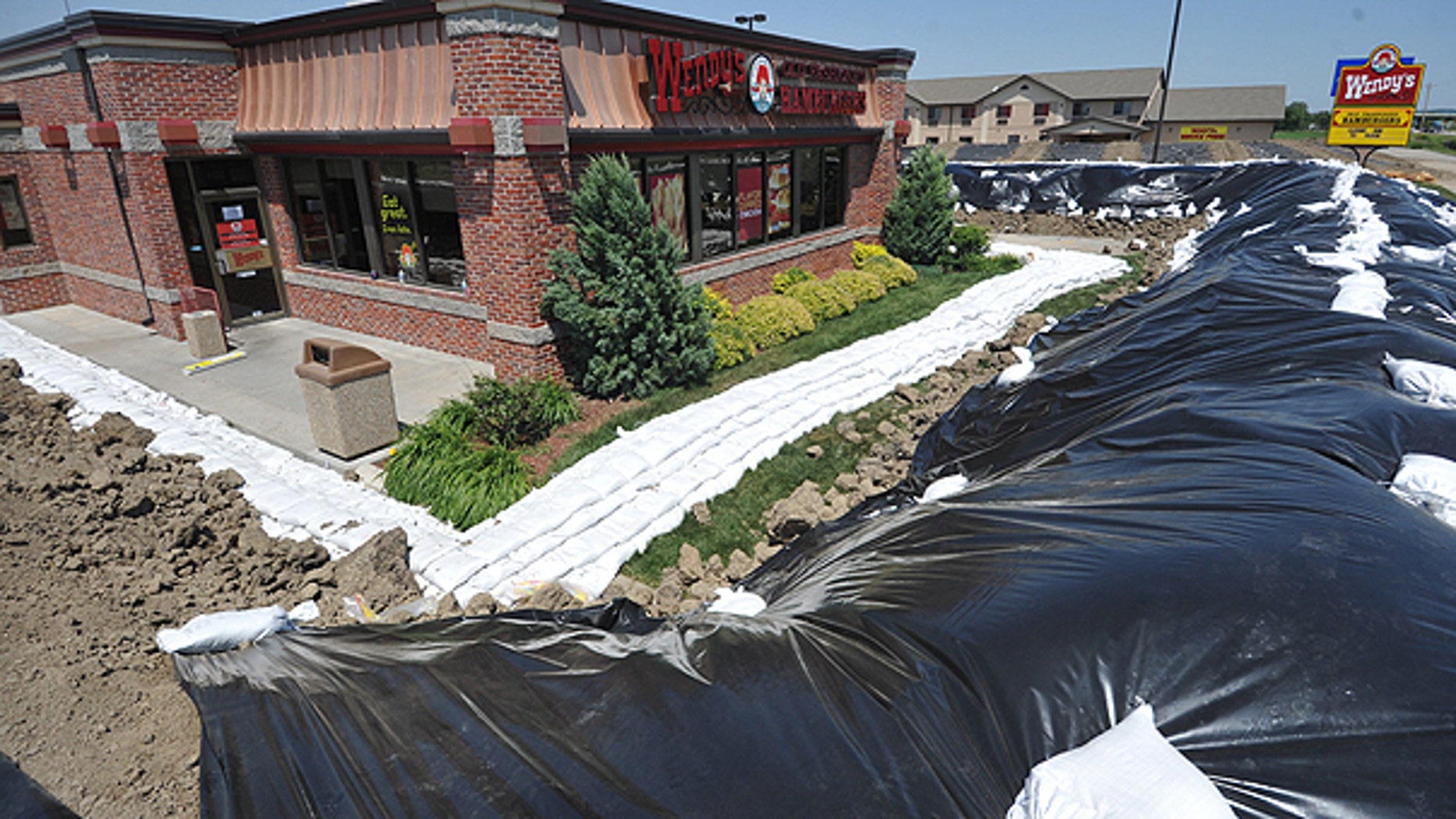 June 6: A Wendy's restaurant is surrounded by a temporary berm in Hamburg, Iowa.