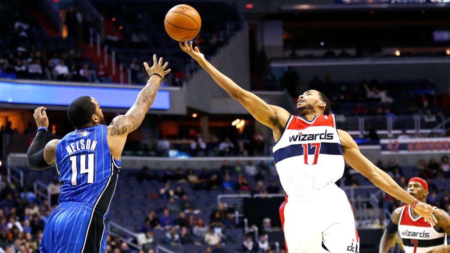 Feb 25, 2014; Washington, DC, USA; Washington Wizards shooting guard Garrett Temple (17) and Orlando Magic point guard Jameer Nelson (14) battle for the ball in the second quarter at Verizon Center. Mandatory Credit: Geoff Burke-USA TODAY Sports