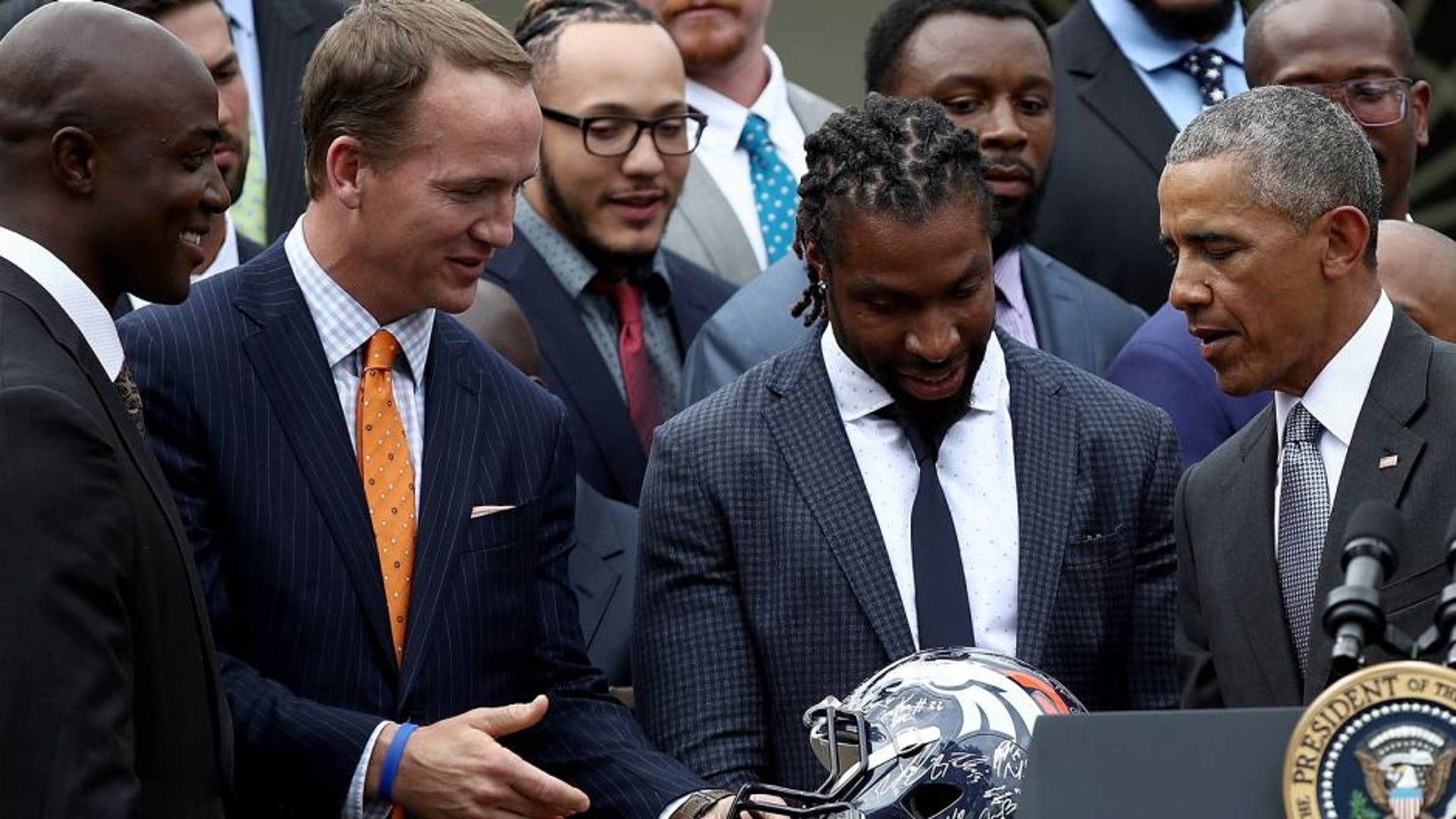 WASHINGTON, DC - JUNE 06: U.S. President Barack Obama is presented with a Denver Broncos helmet by quarterback Peyton Manning while welcoming the National Football League Super Bowl champion Denver Broncos to the White House Rose Garden on June 6, 2016 in Washington, DC. The Broncos defeated the Carolina Panthers 24-10 in Super Bowl 50. (Photo by Win McNamee/Getty Images)