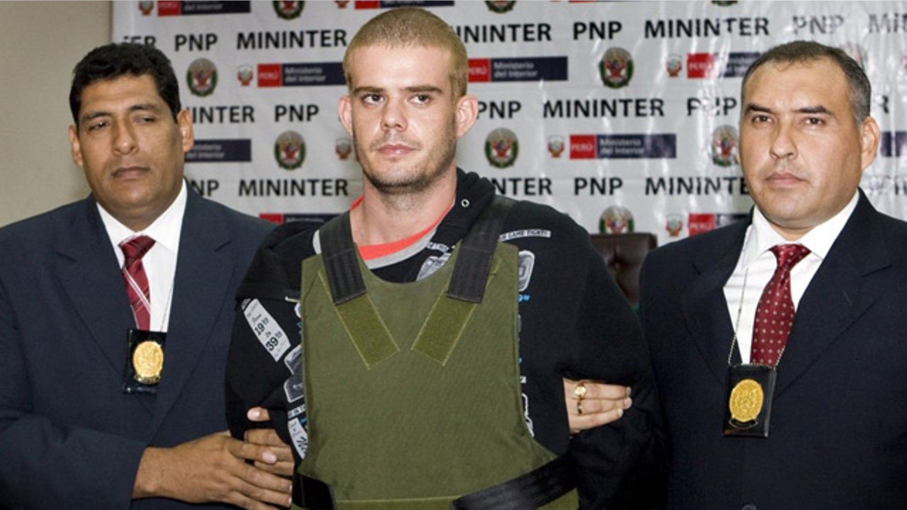 June 5: Joran van der Sloot is escorted by Peruvian police as he arrives at their offices in Lima.