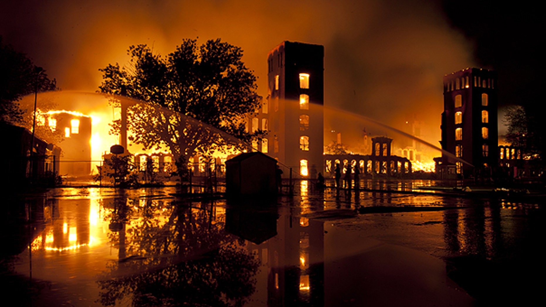 June 7: Firefighters work at the scene of the former Alice Mills Rubber Manufacturing Plant which burns in Woonsocket, R.I.