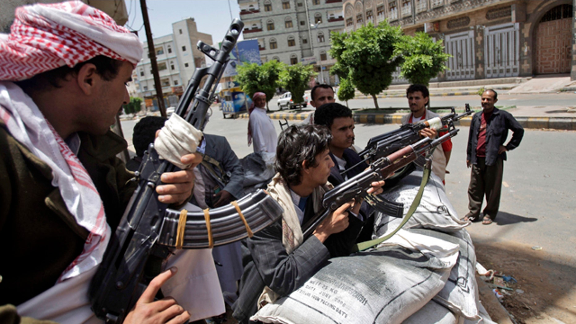 June 6: Armed tribesmen, loyal to Sheik Sadeq al-Ahmar, the head of the powerful Hashid tribe, stand guard in a street corner around al-Ahmar's house during clashes with Yemeni security forces in Sanaa, Yemen.