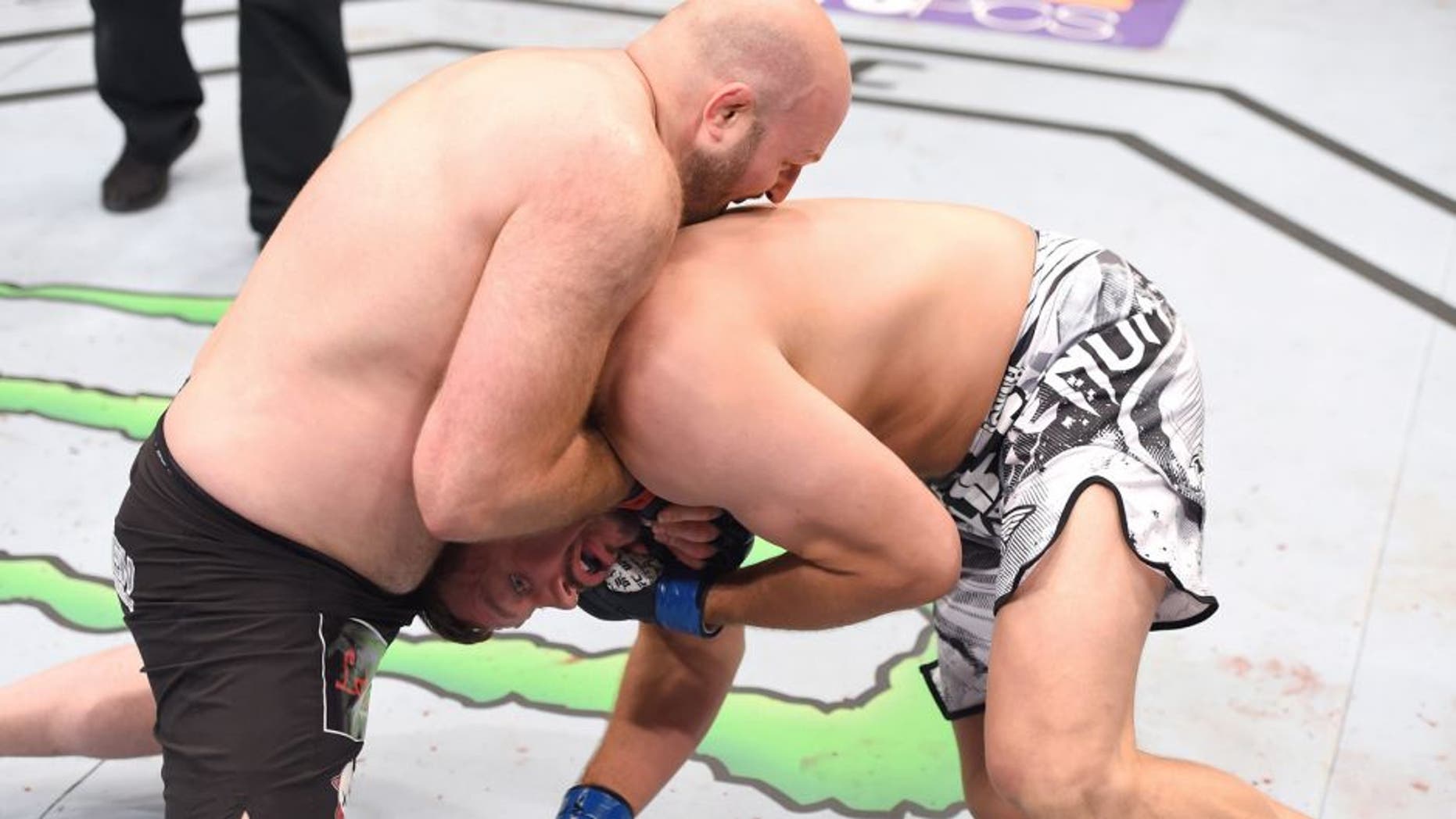 NEW ORLEANS, LA - JUNE 06: (L-R) Ben Rothwell submits Matt Mitrione in their heavyweight bout during the UFC event at the Smoothie King Center on June 6, 2015 in New Orleans, Louisiana. (Photo by Josh Hedges/Zuffa LLC/Zuffa LLC via Getty Images)