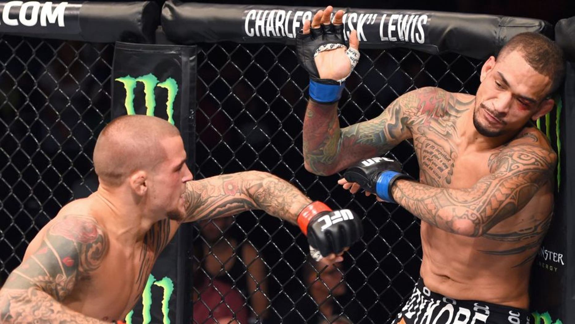 NEW ORLEANS, LA - JUNE 06: (L-R) Dustin Poirier punches Yancy Medeiros in their lightweight bout during the UFC event at the Smoothie King Center on June 6, 2015 in New Orleans, Louisiana. (Photo by Josh Hedges/Zuffa LLC/Zuffa LLC via Getty Images)