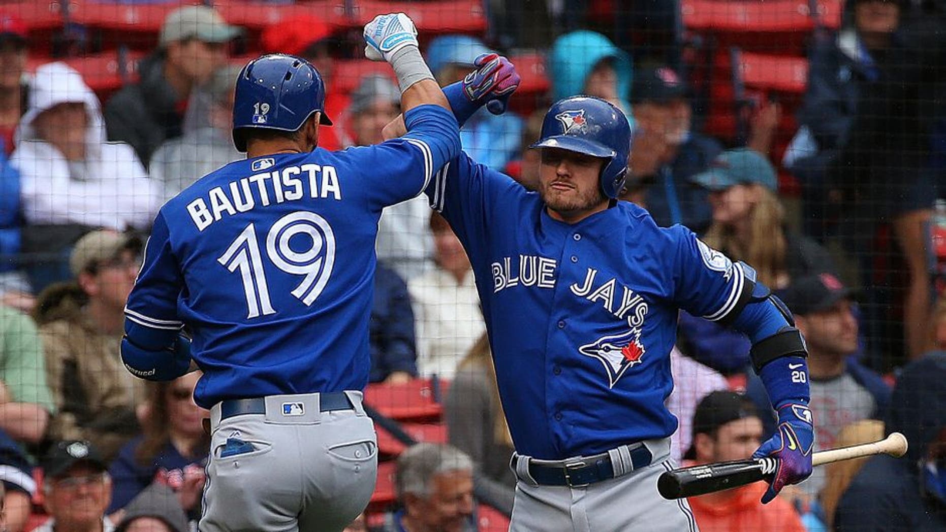 BOSTON, MA - JUNE 5: Jose Bautista #19 of the Toronto Blue Jays celebrates his home run with Josh Donaldson #20 against the Boston Red Sox in the first inning at Fenway Park on June 5, 2016 in Boston, Massachusetts. (Photo by Jim Rogash/Getty Images)