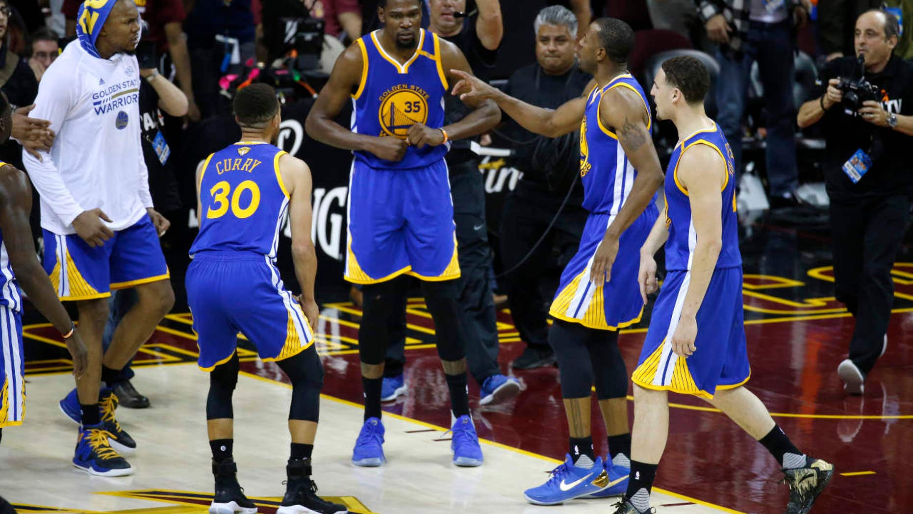 Golden State Warriors forward Kevin Durant (35) celebrates with teammates after the Warriors defeated the Cleveland Cavaliers 118-113 in Game 3 of basketball's NBA Finals in Cleveland, Wednesday, June 7, 2017.