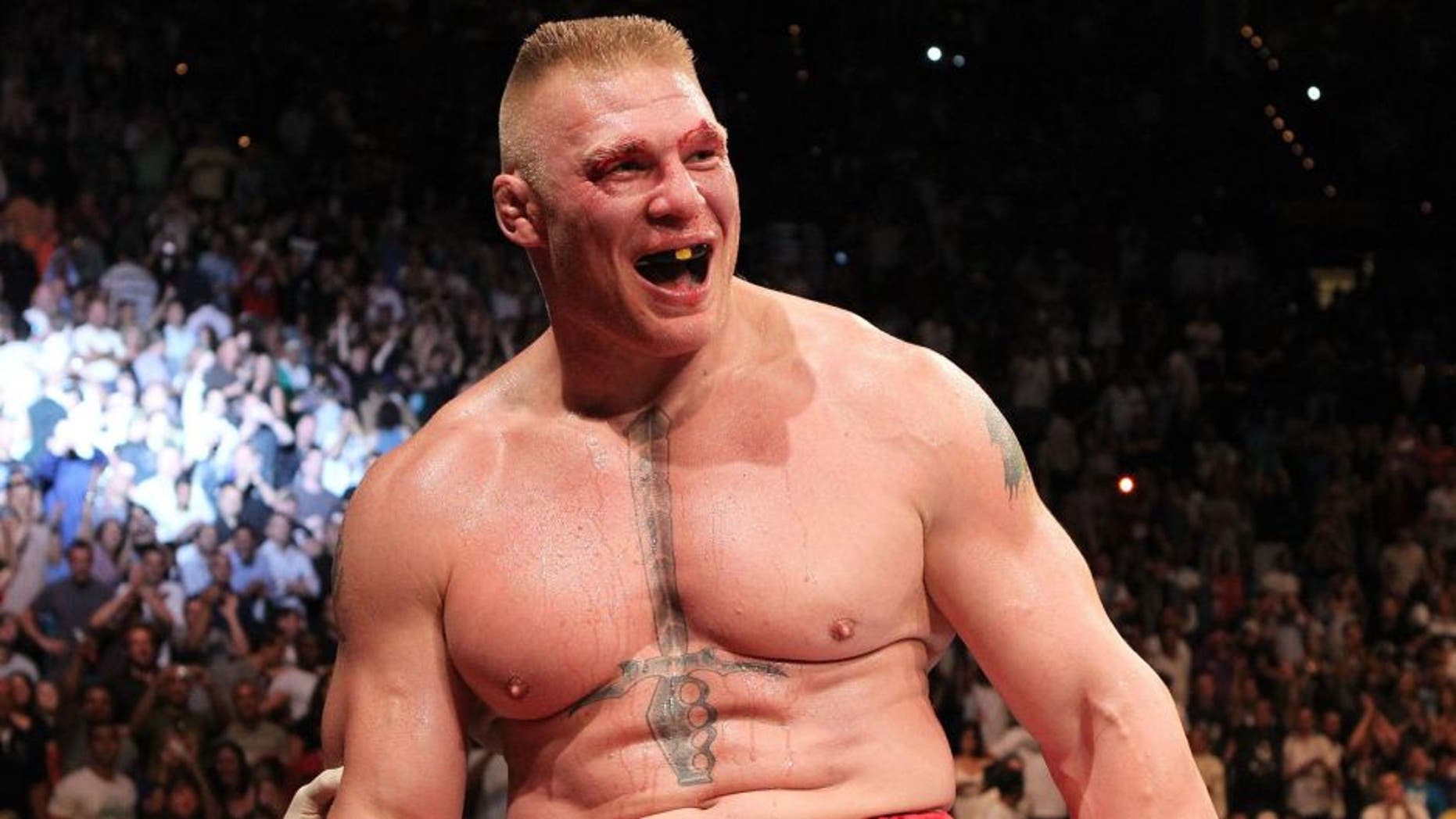 (L-R) Brock Lesnar throws a right to the face of Shane Carwin during the UFC Heavyweight Championship Unification bout at the MGM Grand Garden Arena on July 3, 2010 in Las Vegas, Nevada.