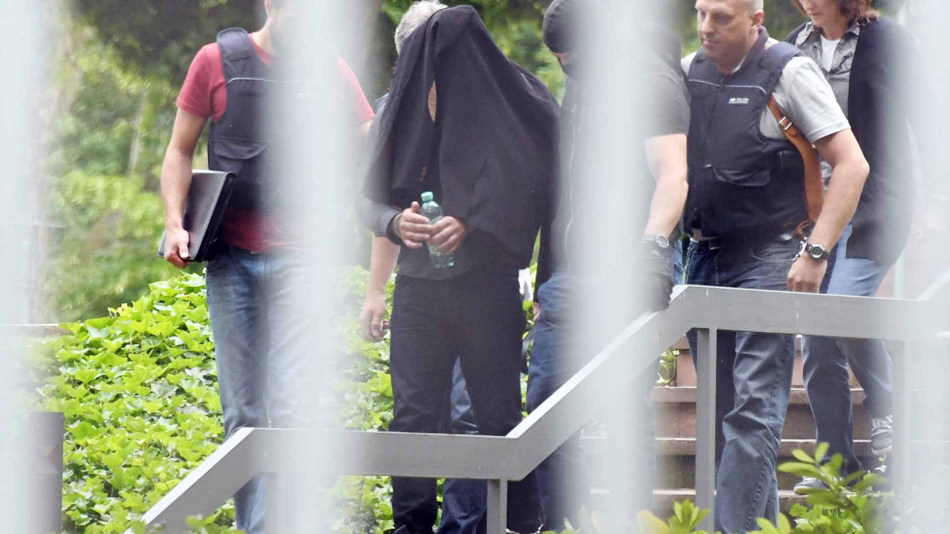 June 2, 2016: An alleged terror suspect is led by police at the Federal court in Karlsruhe, Germany.