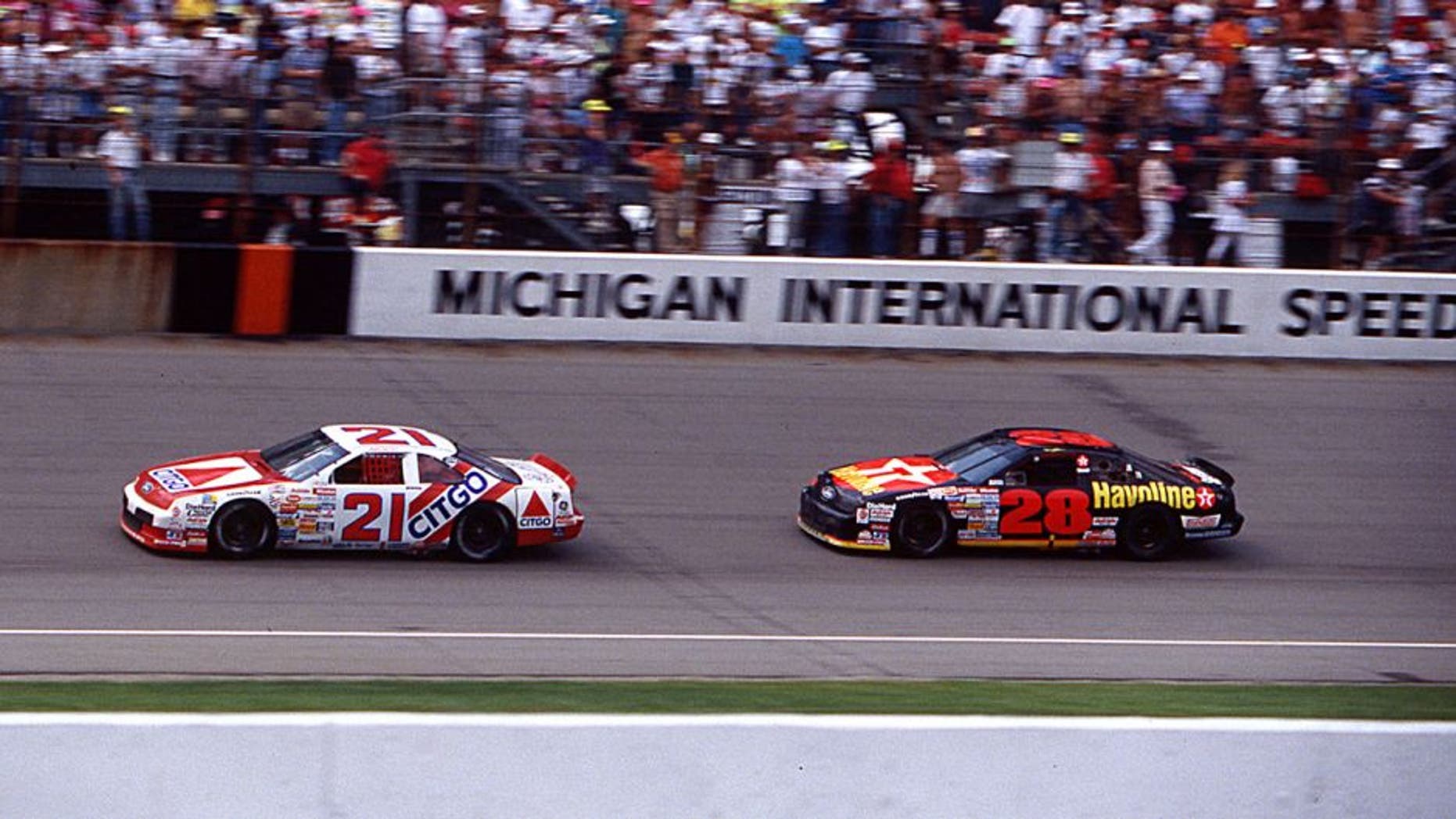 BROOKLYN, MI â August 18, 1991: Dale Jarrett (No. 21) in the Wood Brothers Citgo Ford leads Davey Allison (No. 28) to the checkered flag to win his first NASCAR Cup race, the Champion Spark Plug 400 at Michigan International Speedway. (Photo by ISC Images & Archives via Getty Images)