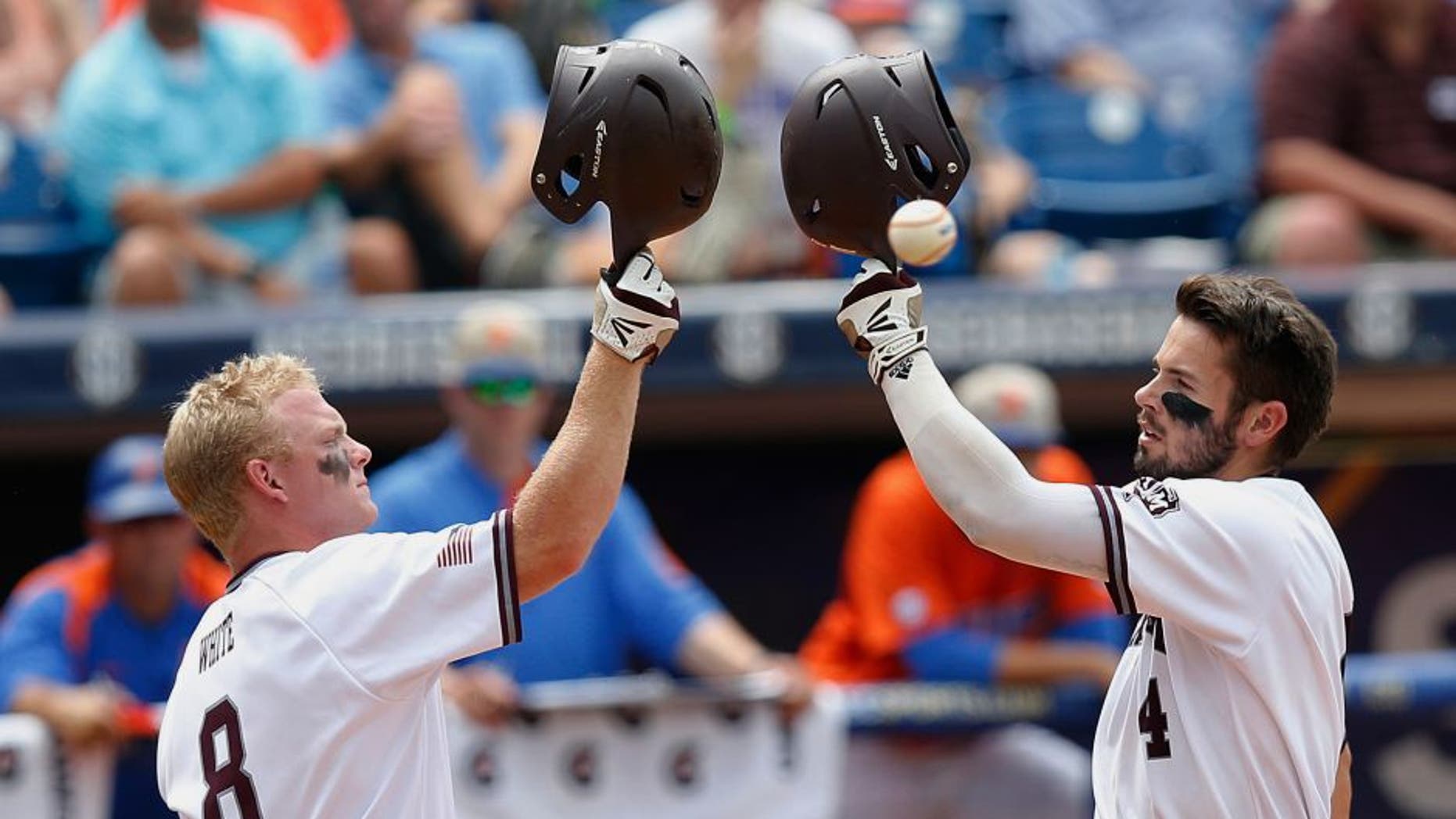 Texas A&M's Nick Banks, right, celebrates with Boomer White after Banks hits a solo home run in the third inning of the Southeastern Conference NCAA college baseball championship game at the Hoover Met, Sunday, May 29, 2016, in Hoover, Ala. Texas A&M won 12-5. (AP Photo/Brynn Anderson)
