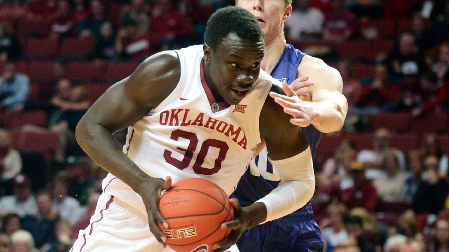 Feb 2, 2016; Norman, OK, USA; Oklahoma Sooners center Akolda Manyang (30) drives to the basket in front of TCU Horned Frogs forward Vladimir Brodziansky (10) during the second half at Lloyd Noble Center. Mandatory Credit: Mark D. Smith-USA TODAY Sports