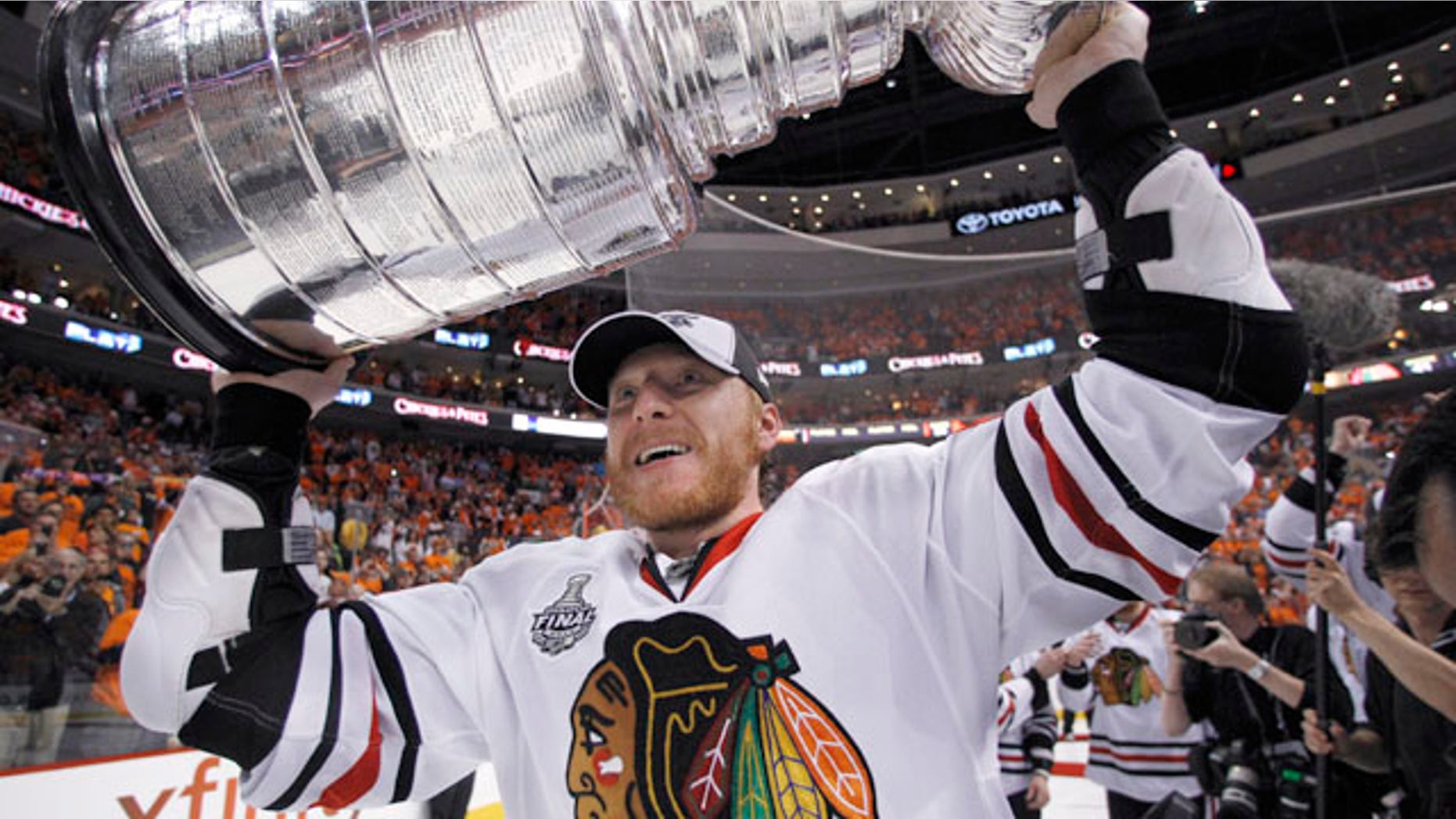 June 9: Chicago Blackhawks right wing Marian Hossa, of Slovakia, carries the Stanley Cup.