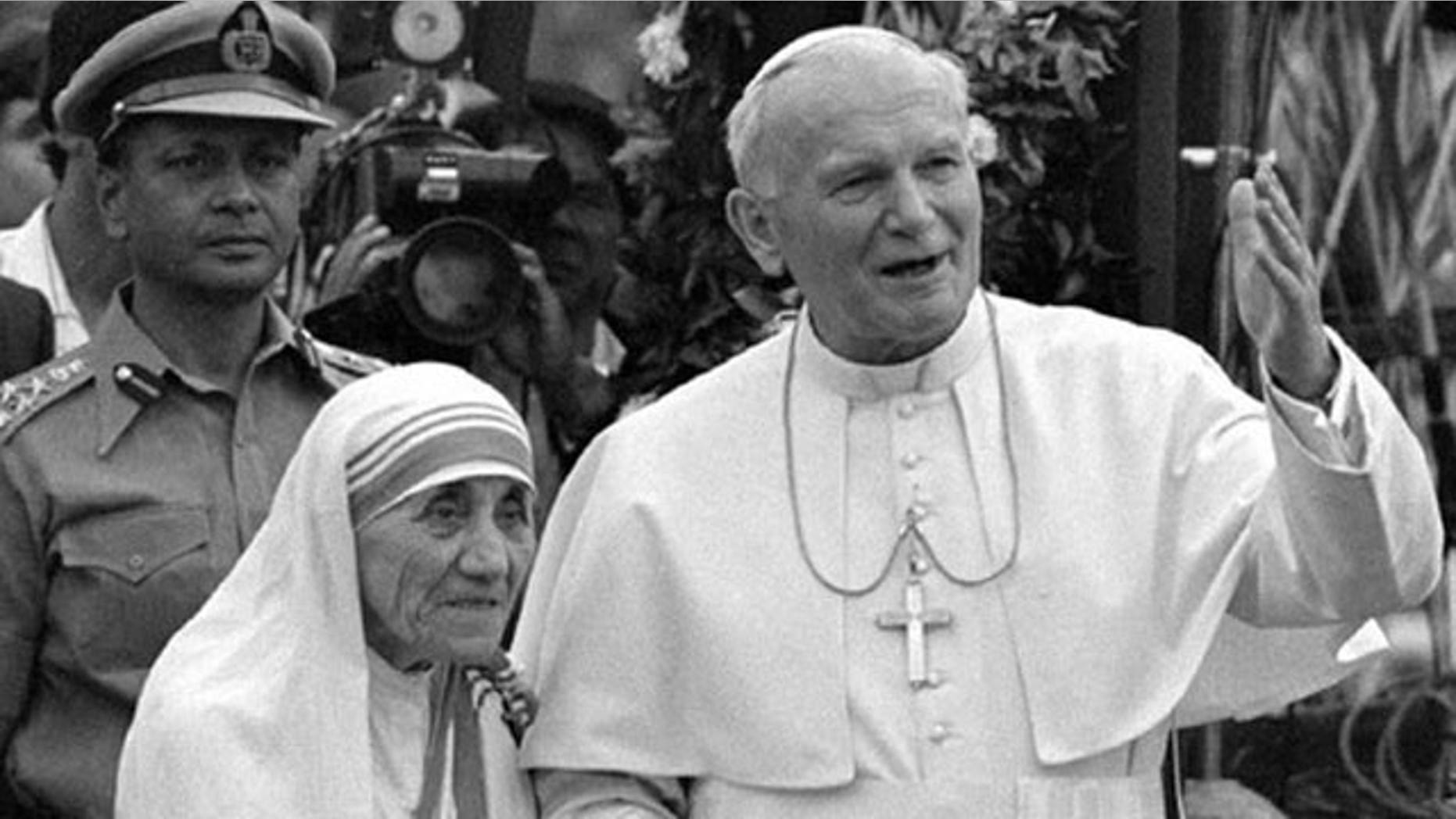 Pope John Paul II holds hands with Mother Teresa after visiting the Casa del Cuore Puro, Mother Teresa's home for the destitute and dying in the eastern Indian city of Calcutta, in this Feb. 3, 1986 file photo.