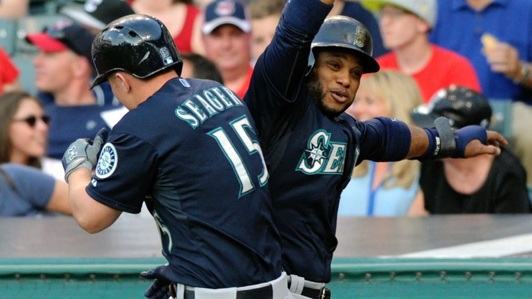 Jun 10, 2015; Cleveland, OH, USA; Seattle Mariners third baseman Kyle Seager (15) celebrates with second baseman Robinson Cano (22) after hitting a grand slam home run during the third inning against the Cleveland Indians at Progressive Field. Mandatory Credit: Ken Blaze-USA TODAY Sports