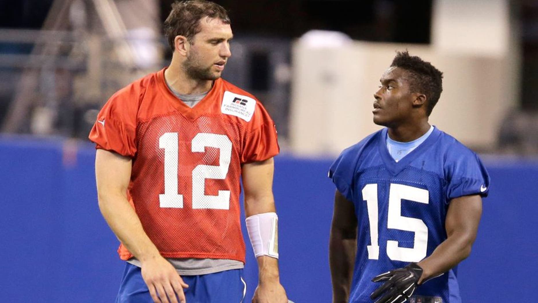 Indianapolis Colts quarterback Andrew Luck (12) talks with Phillip Dorsett during an NFL football organized team activity Wednesday, June 10, 2015, in Indianapolis. (AP Photo/Darron Cummings)