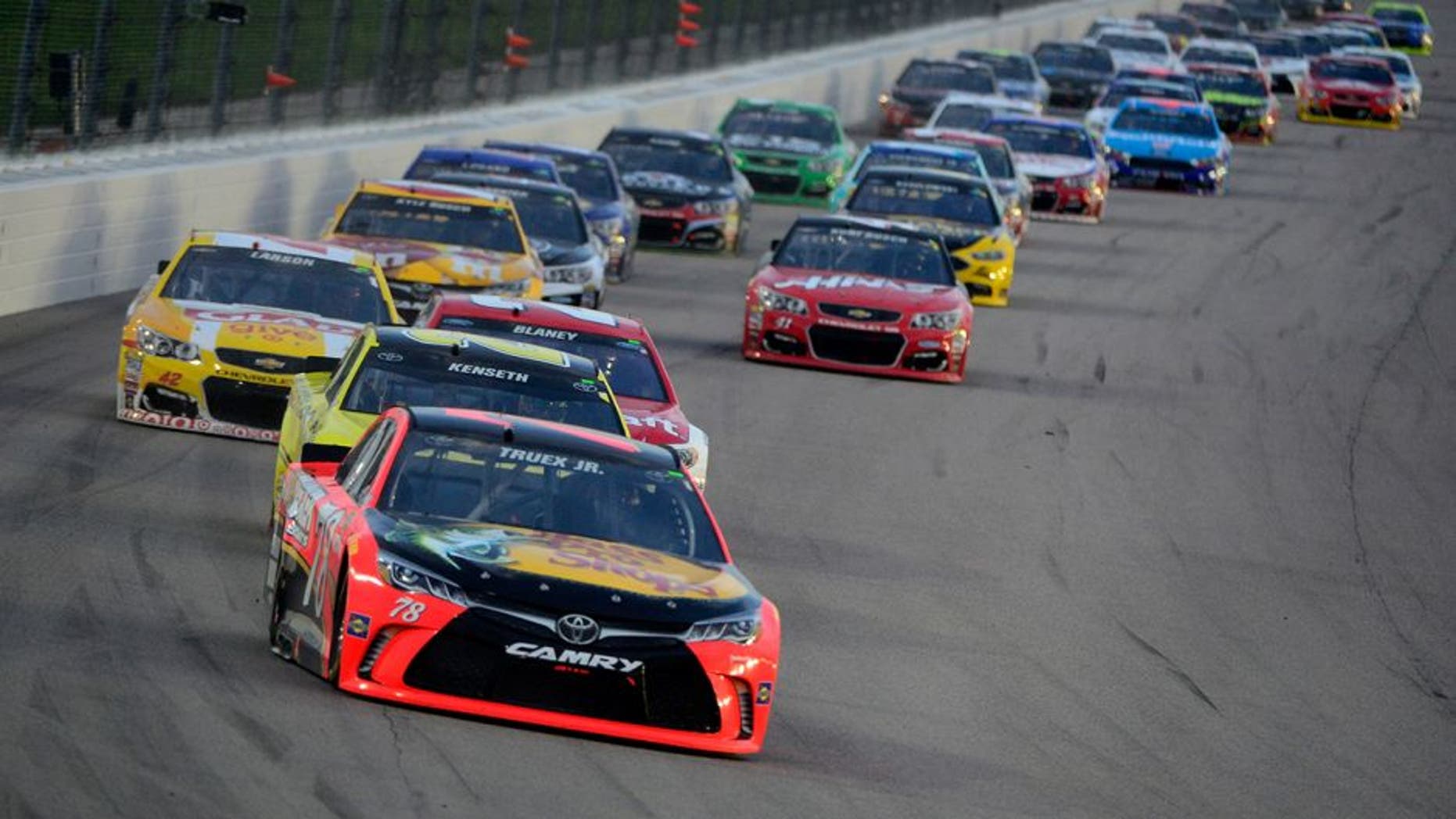KANSAS CITY, KS - MAY 07: Martin Truex Jr., driver of the #78 Bass Pro Shops/TRACKER Boats Toyota Toyota, and Matt Kenseth, driver of the #20 Dollar General Toyota, leads the field during the NASCAR Sprint Cup Series Go Bowling 400 at Kansas Speedway on May 7, 2016 in Kansas City, Kansas. (Photo by Robert Laberge/NASCAR via Getty Images)