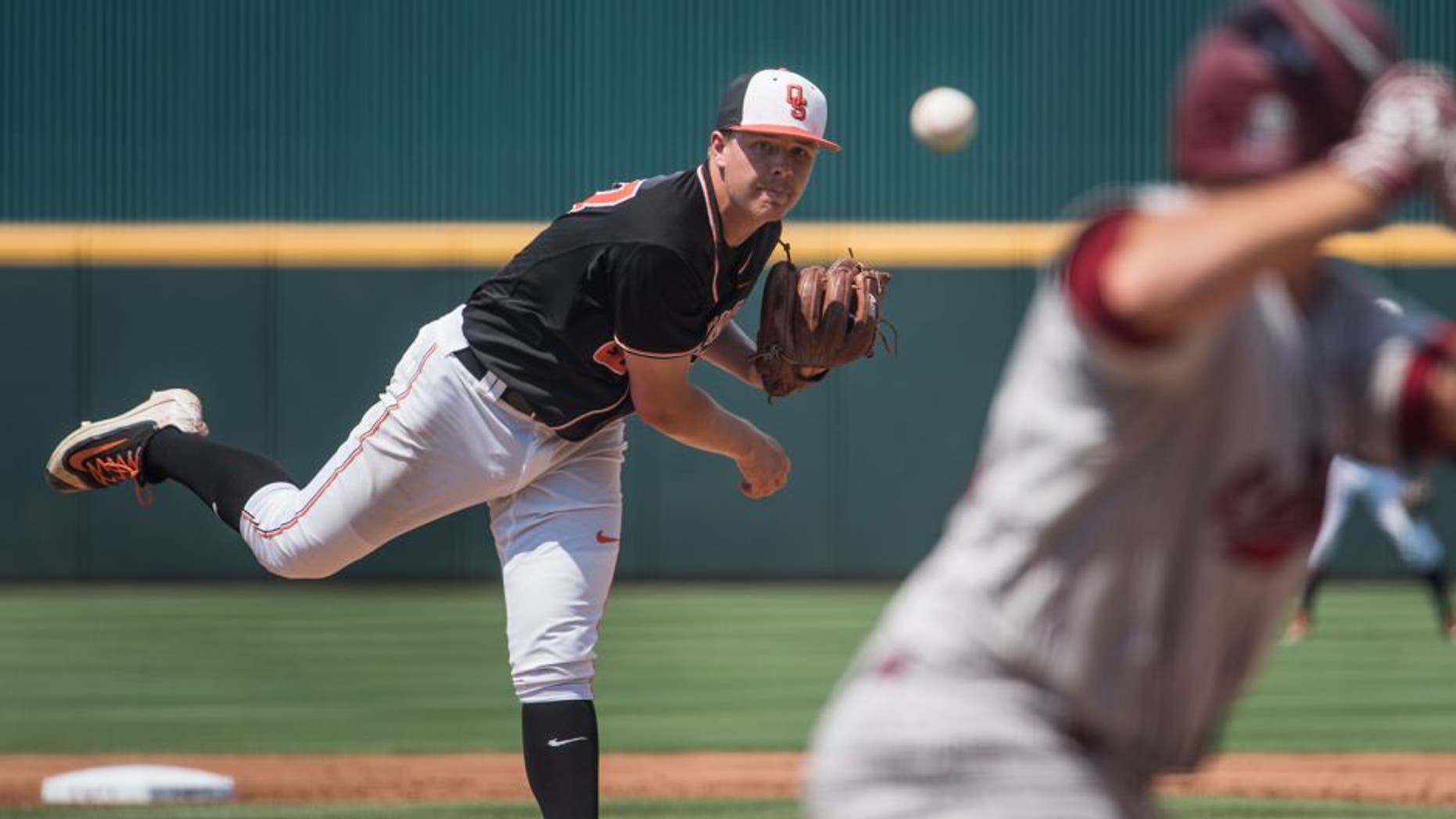 Oklahoma State pitcher Tyler Buffett delivers a pitch during an NCAA college baseball tournament super regional game against South Carolina on Sunday, June 12, 2016, in Columbia, S.C. (AP Photo/Sean Rayford)