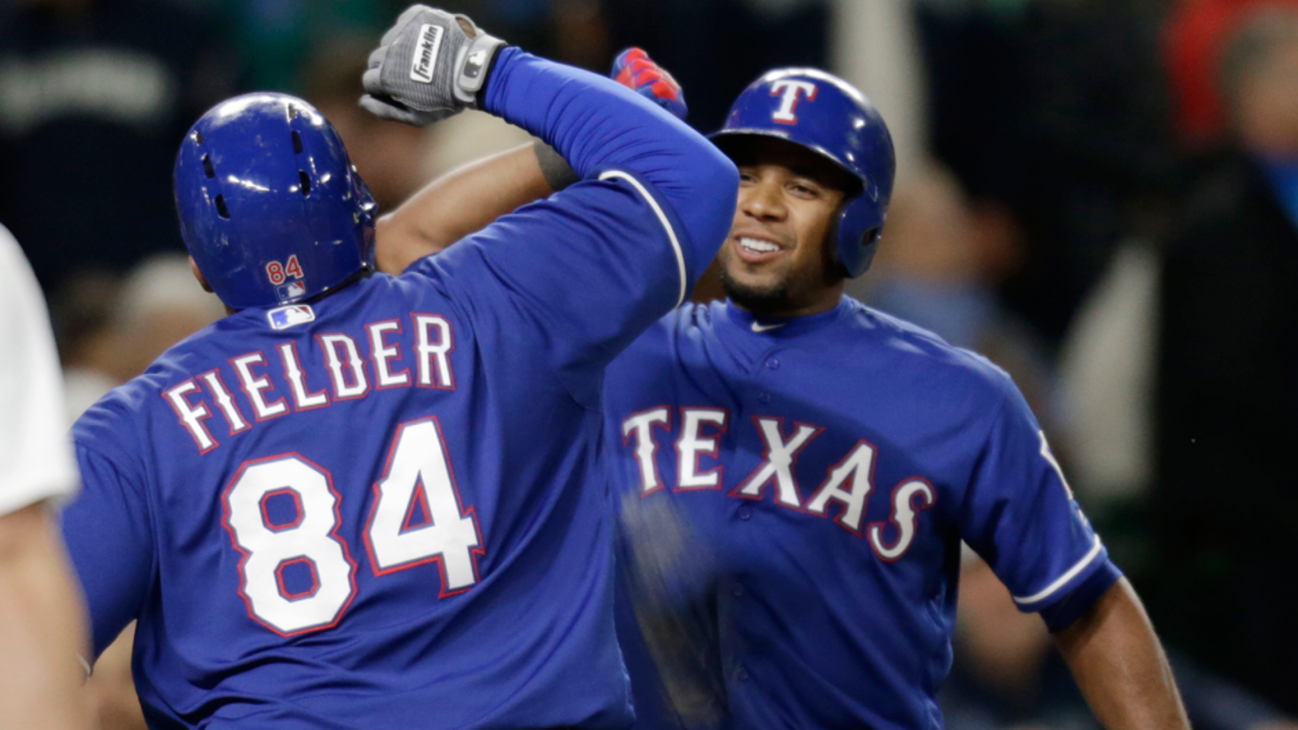 Texas Rangers' Prince Fielder celebrates with Elvis Andrus, right, after Ardus hit a solo home run on a pitch from Seattle Mariners' Steve Cishek to tie a baseball game in the ninth inning Saturday, June 11, 2016, in Seattle. (AP Photo/John Froschauer)
